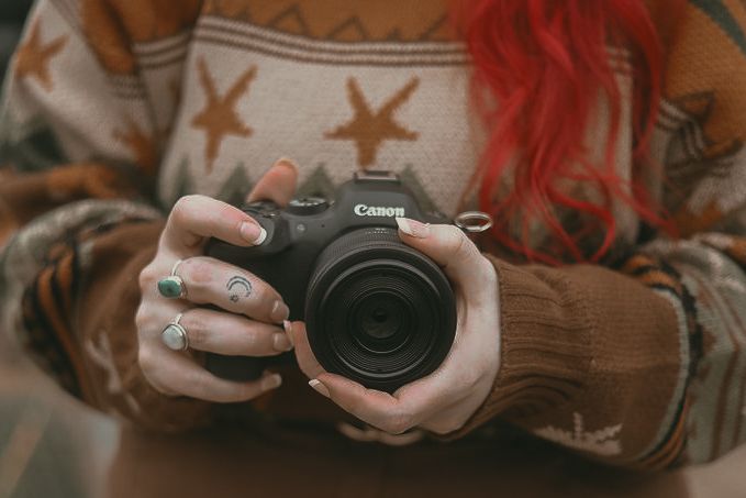 Photographer holding camera in Cleveland Ohio by Gypsy Lens Photography a documentary wedding photographer, moody, intimate, nostalgic