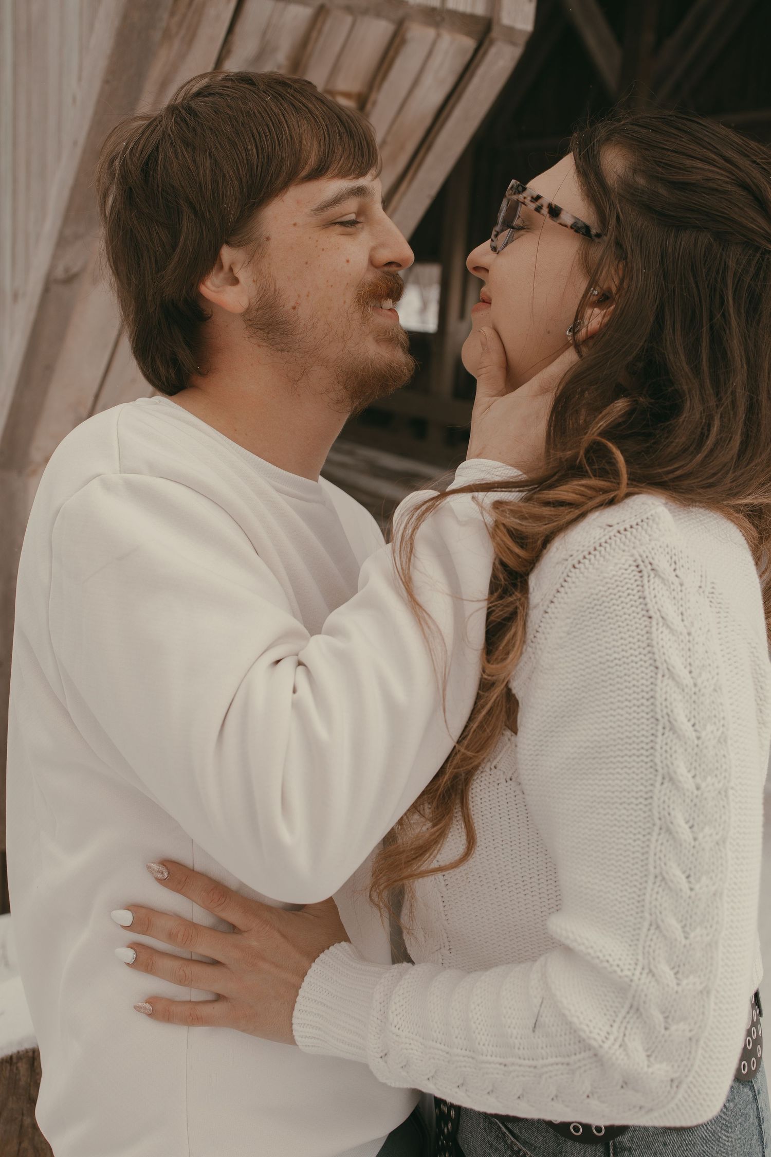 Romantic couple kissing at covered bridge in Ashtabula Ohio by Gypsy Lens Photography. Moody, vintage, documentary wedding photographer.