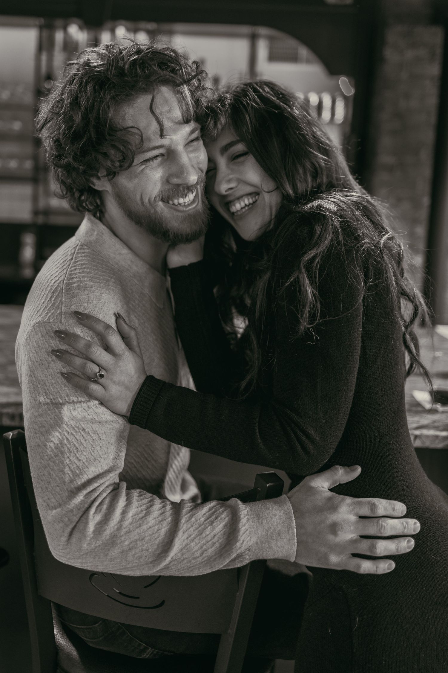 Engaged couple laughing at wine cellar in Cleveland Ohio by Gypsy Lens Photography. Moody, vintage, documentary wedding photographer.