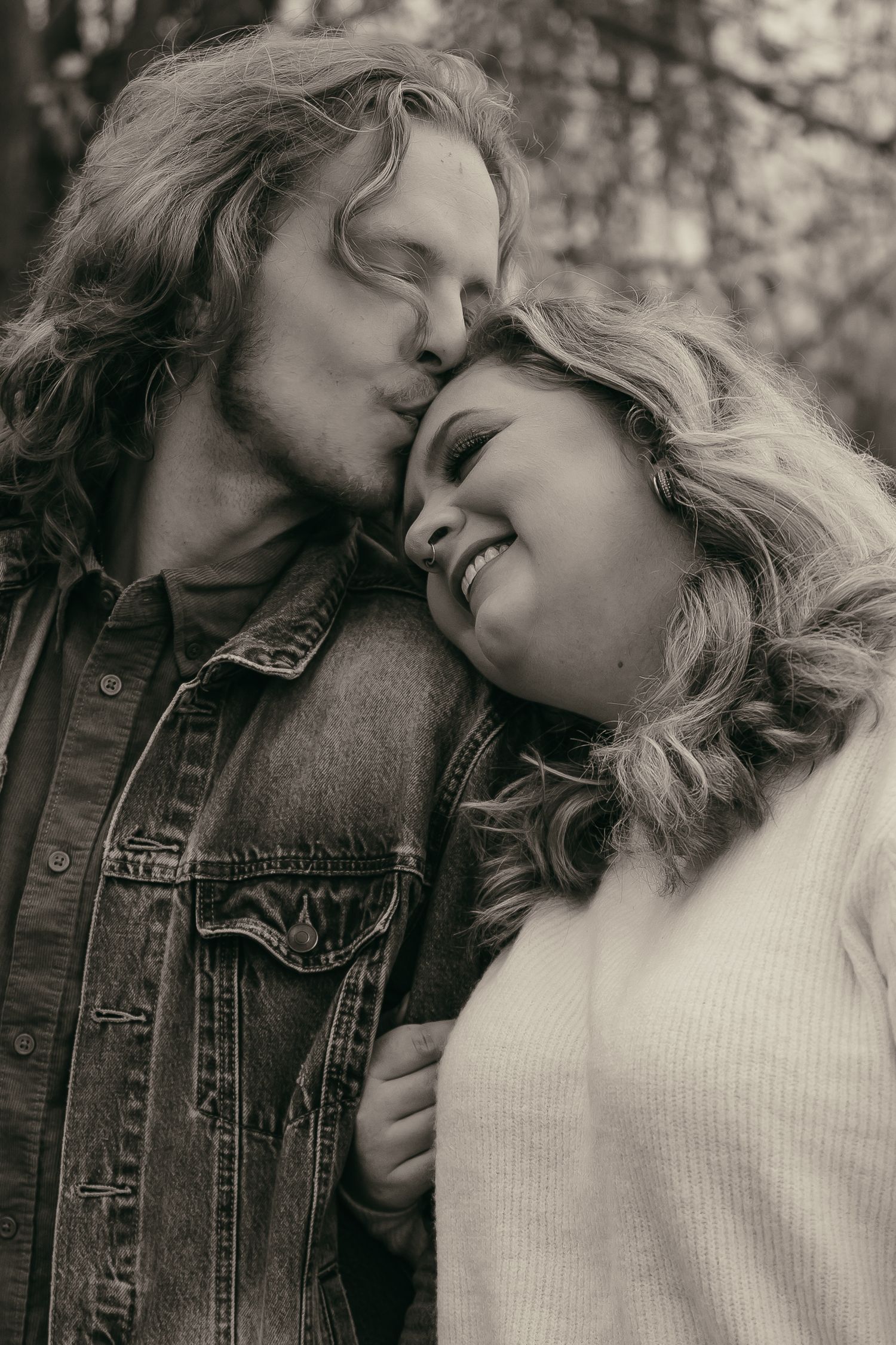 Black and white of couple kissing in Lake County Ohio by Gypsy Lens Photography. Moody, filmy, vintage, documentary wedding photography