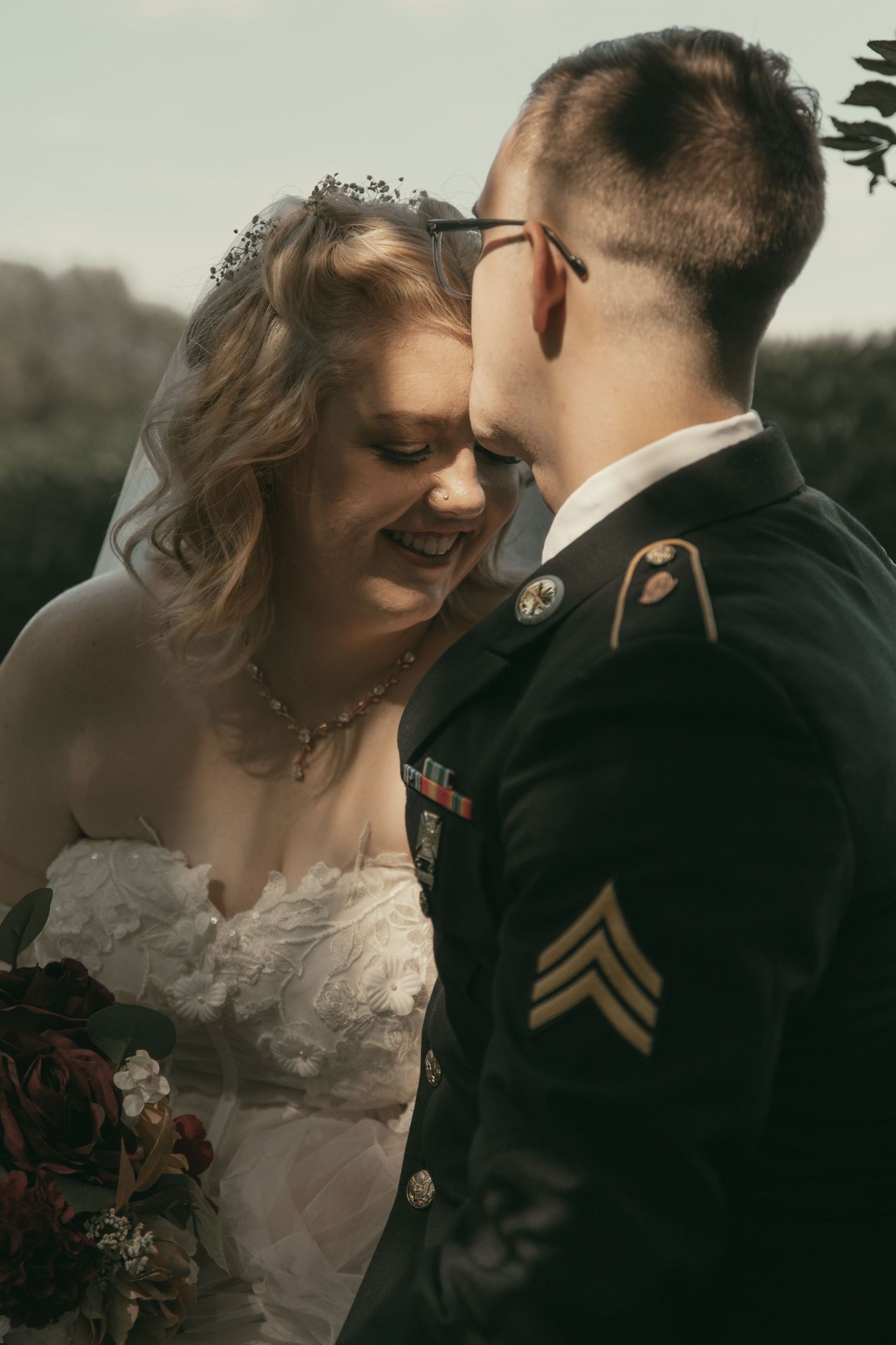 Military wedding couple sharing an intimate moment in Wooster Ohio by Gypsy Lens Photography. Moody, vintage, nostalgic, documentary wedding