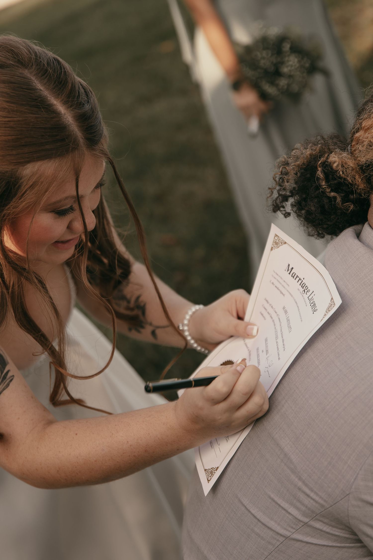 Brides signing marriage license in Cleveland Ohio by Gypsy Lens Photography. Moody, vintage, documentary wedding photography.