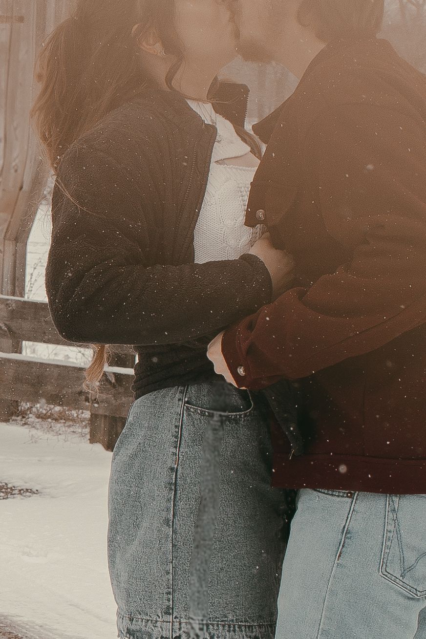 Close-up of two people in winter clothing at covered bridge in Ashtabula Ohio by Gypsy Lens Photography. Moody, vintage, documentary.