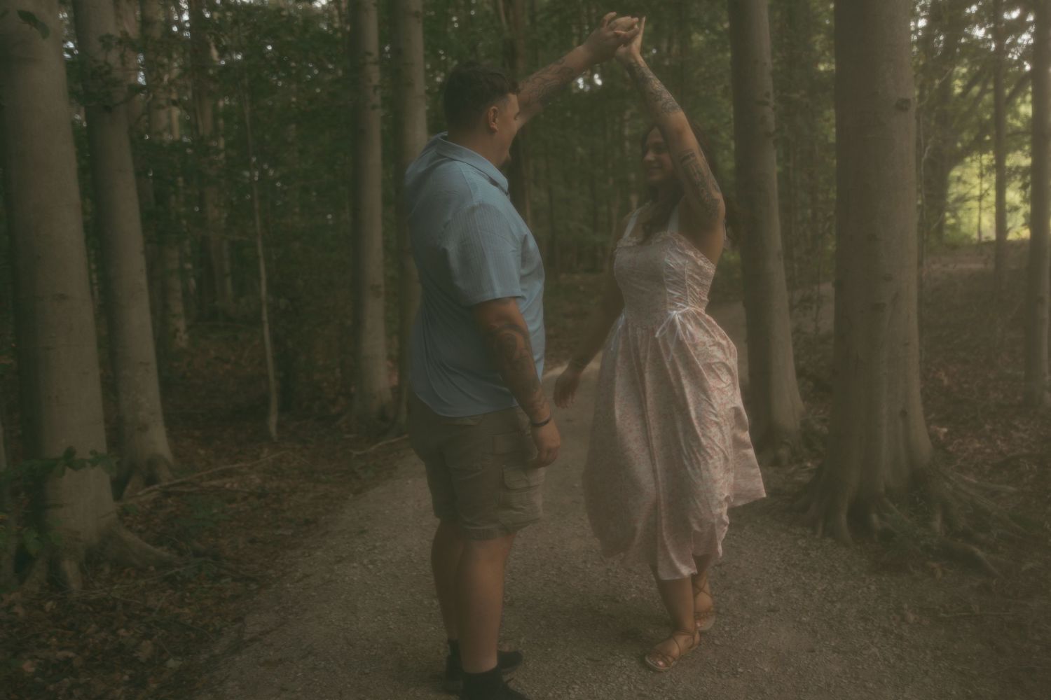 Engaged couple dancing with grain in Lake County Ohio by Gypsy Lens Photography. Moody, filmy, vintage, documentary wedding photography