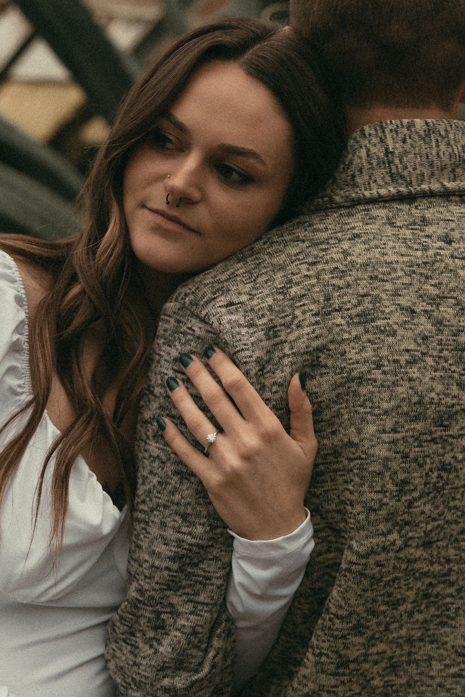 Grainy close up of engagement ring in Cleveland Ohio by Gypsy Lens Photography. Moody, filmy, vintage, documentary wedding photography