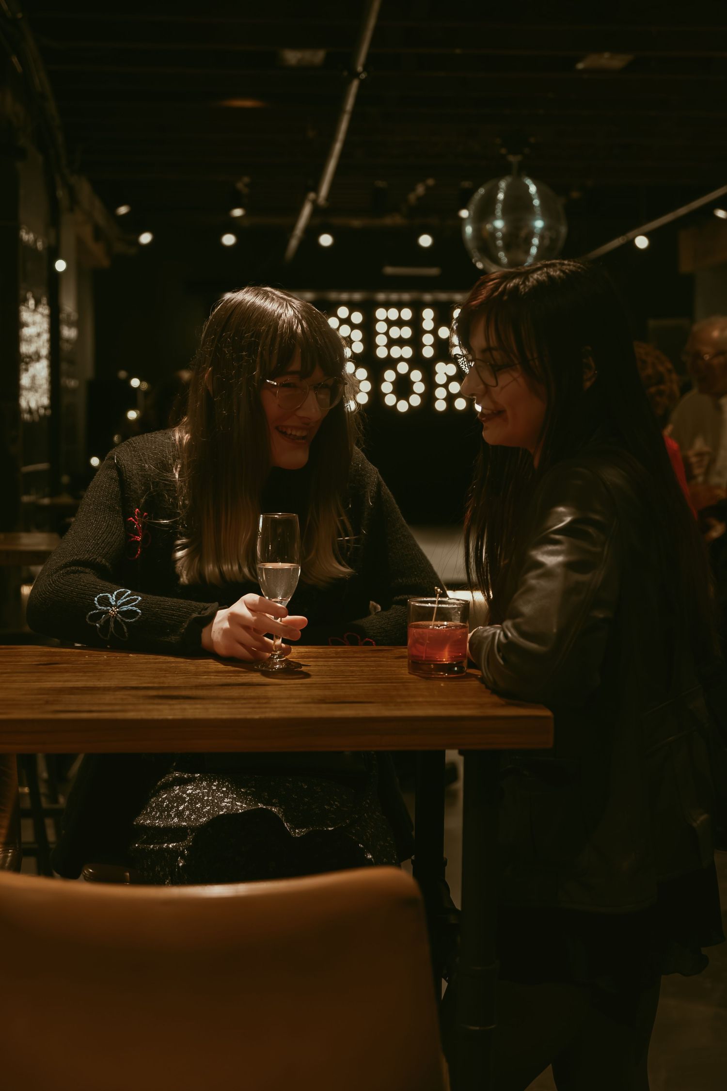 Couple laughing at cocktail hour in Cleveland Ohio by Gypsy Lens Photography. Moody, filmy, vintage, documentary wedding photography.
