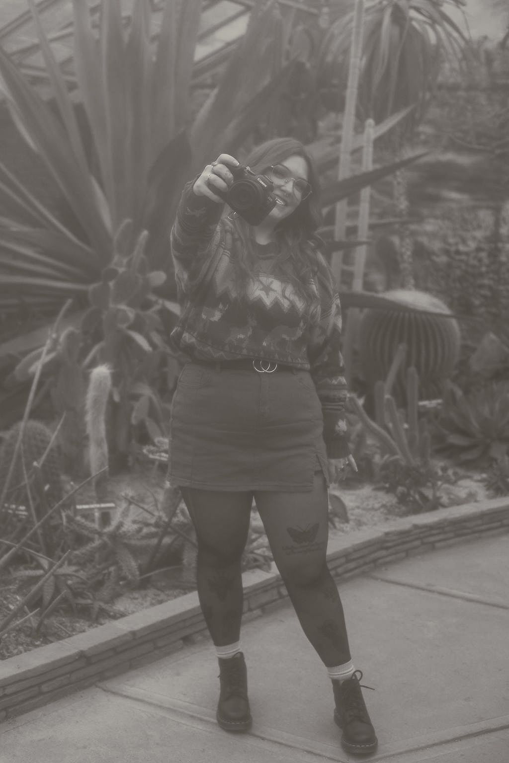 A moody, vintage, film inspired photo of a photographer holding their camera in Cleveland Ohio by Gypsy Lens Photography, wedding photograph