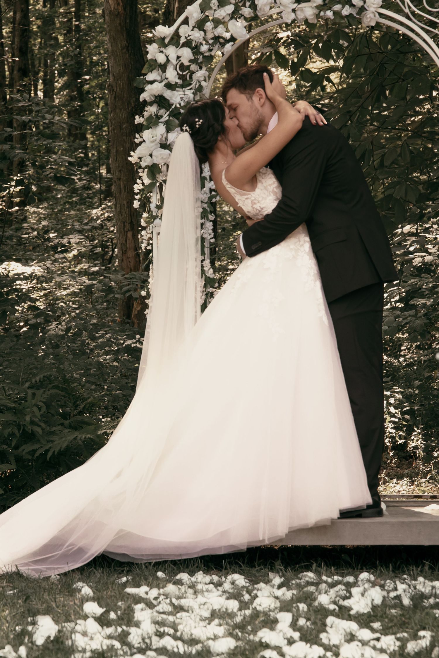 Romantic first kiss during ceremony in Tallmadge Ohio by Gypsy Lens Photography. Moody, vintage, nostalgic documentary wedding photographer.