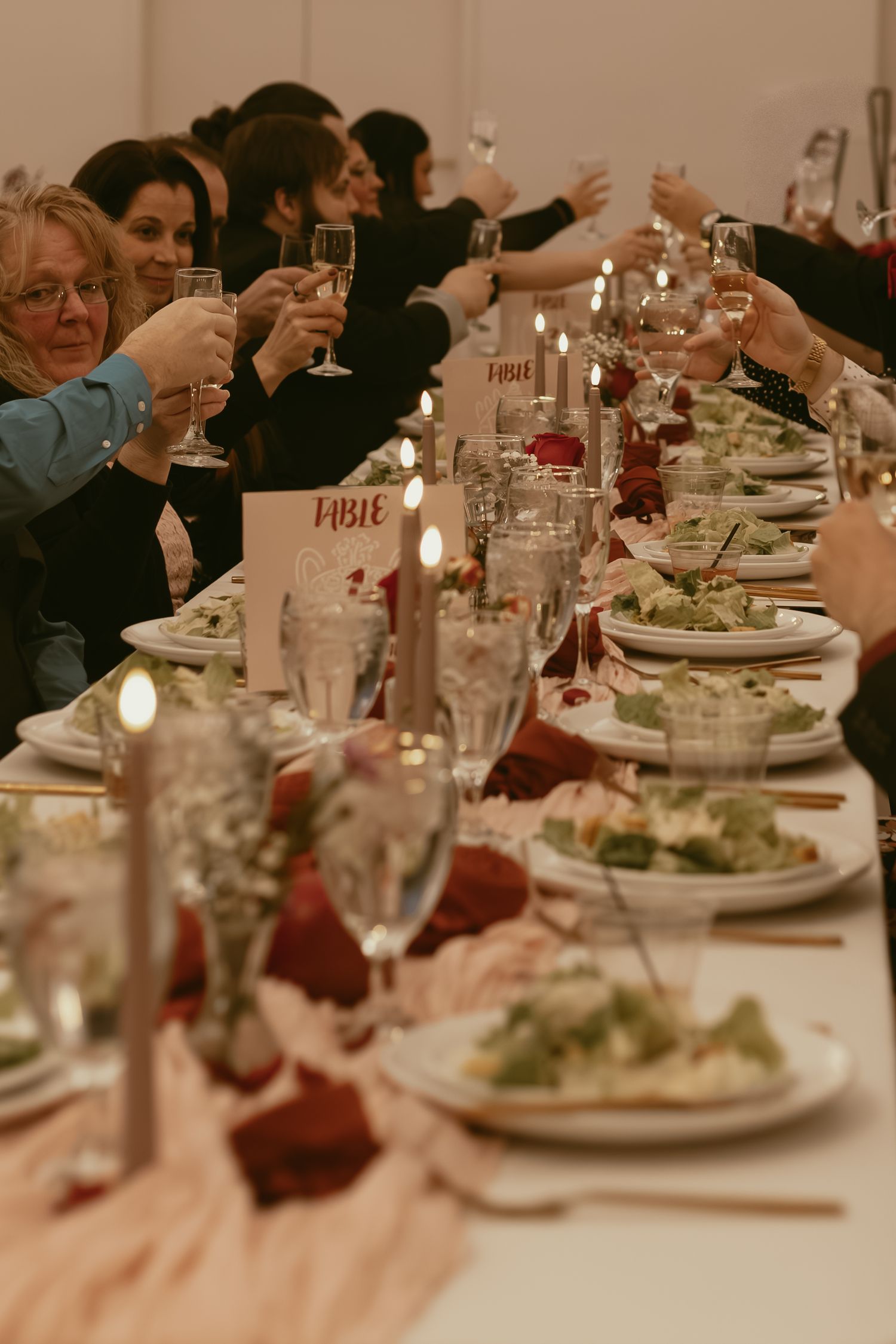 Tablescape of wedding guests toasting in Cleveland Ohio by Gypsy Lens Photography. Moody, filmy, vintage, documentary wedding photography.