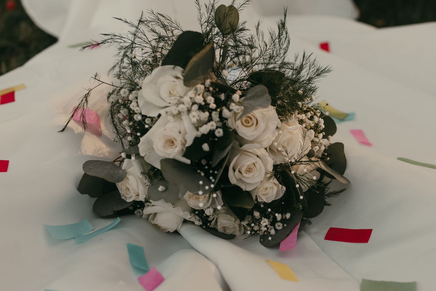 Bridal bouquet covered in confetti in Cleveland Ohio by Gypsy Lens Photography. Moody, vintage, documentary wedding photography.