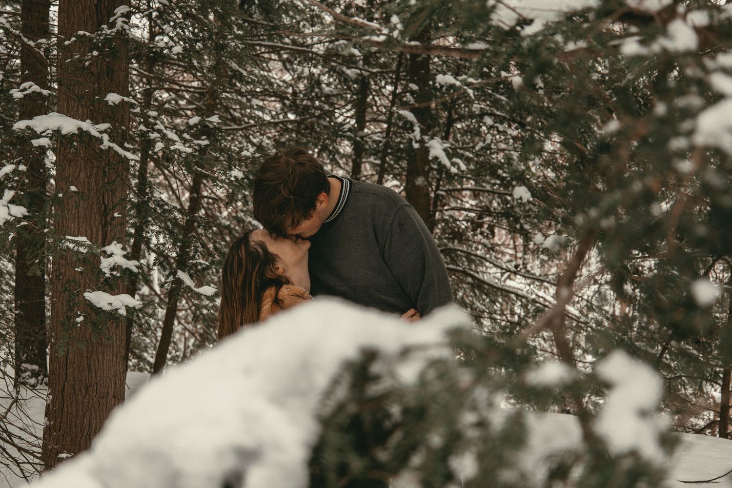 An intimate winter kiss in Lake County Ohio by Gypsy Lens Photography. Moody, vintage, documentary wedding photographer.