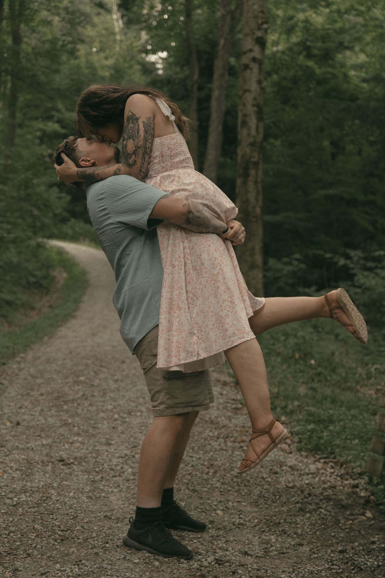 Engaged couple spinning around in Lake County Ohio by Gypsy Lens Photography. Moody, filmy, vintage, documentary wedding photography
