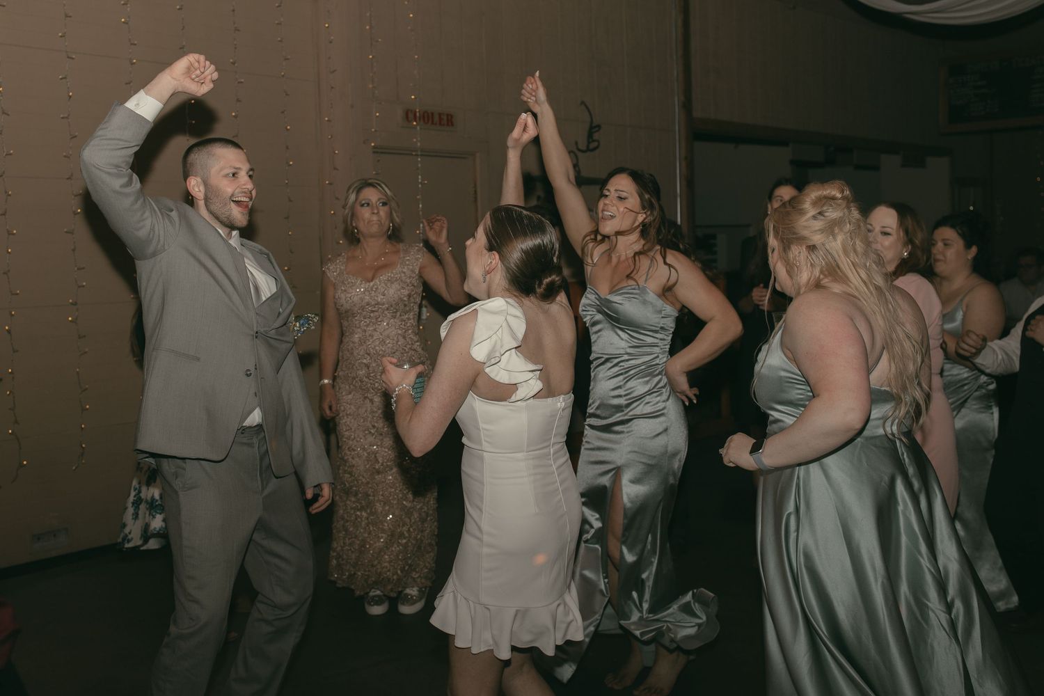 Wedding reception dance floor filled with guests in Ashtabula Ohio by Gypsy Lens Photography. Moody, vintage, nostalgic documentary wedding.