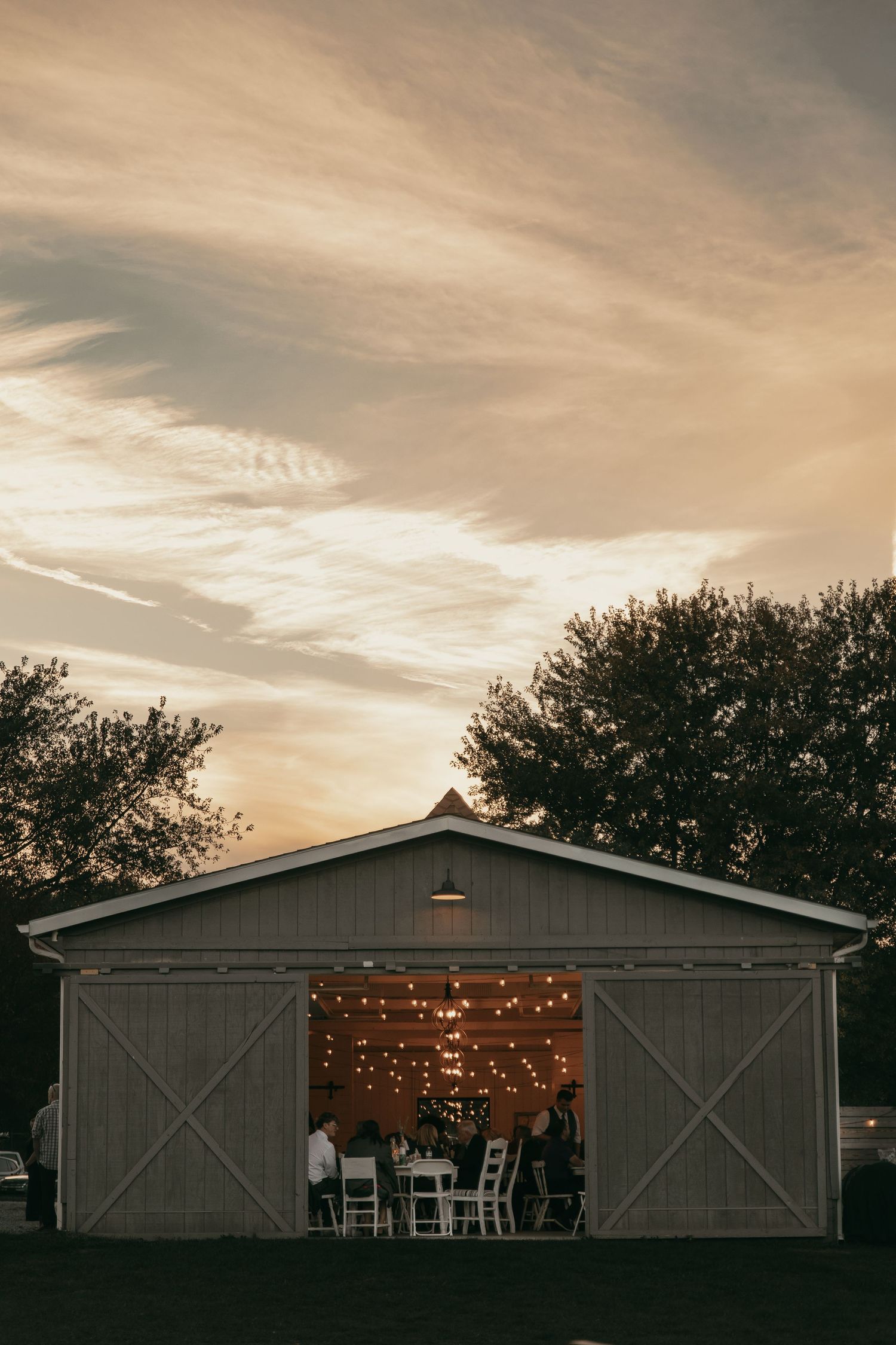 Rustic barn reception venue at sunset in Cleveland Ohio by Gypsy Lens Photography. Moody, vintage, documentary wedding photography.