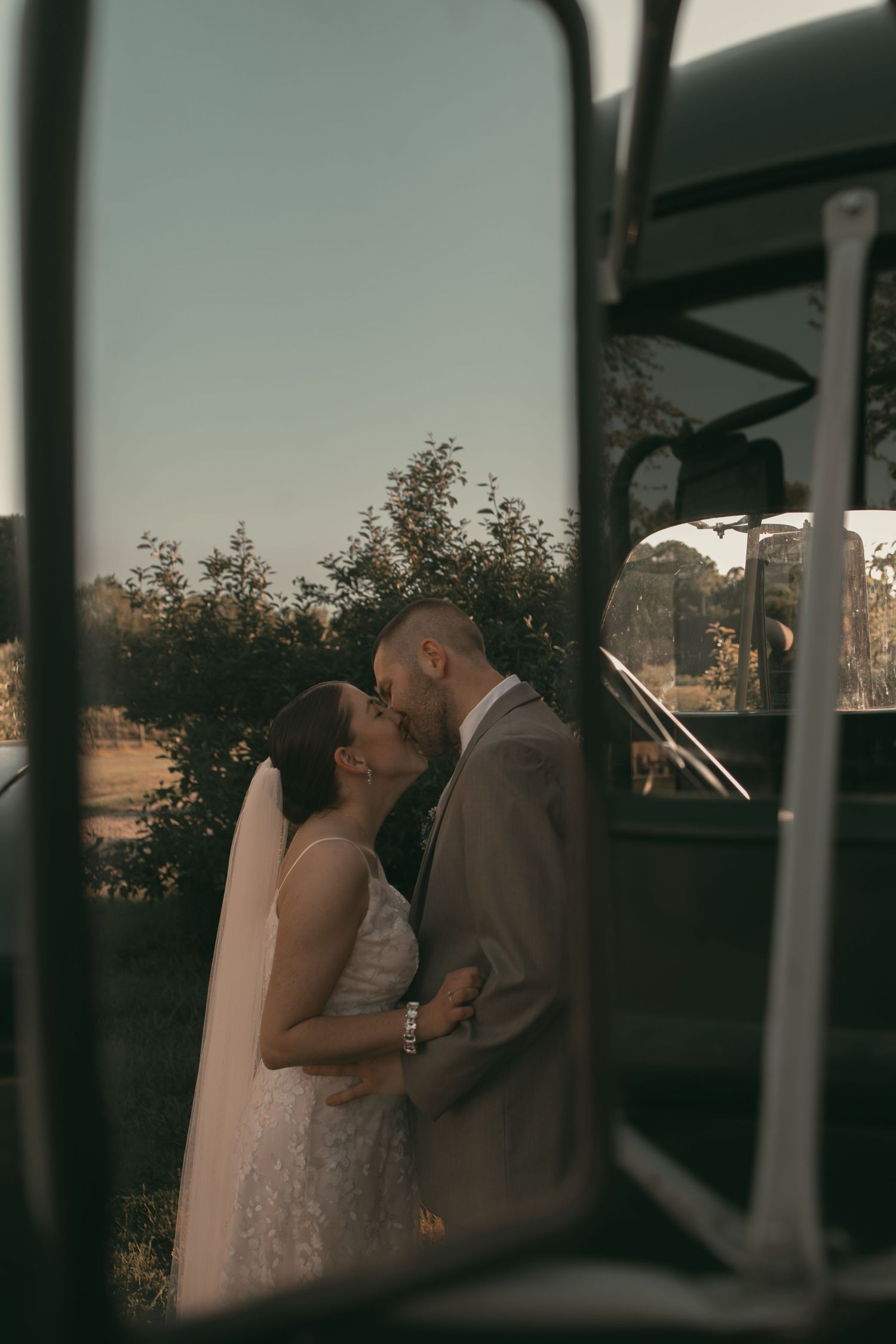 Romantic moment captured through vintage car window frame in Ashtabula Ohio by Gypsy Lens Photography. Moody, vintage, nostalgic documentary