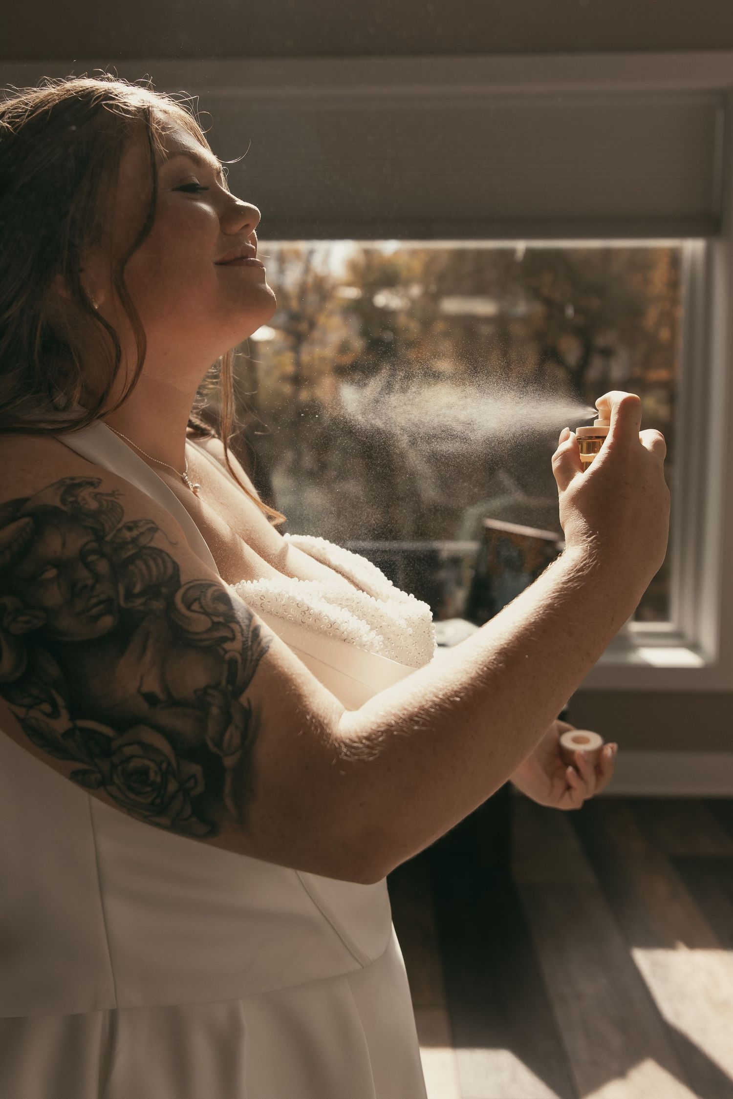 Bride putting on perfume before wedding in Cleveland Ohio by Gypsy Lens Photography. Moody, filmy, vintage, documentary wedding photography.