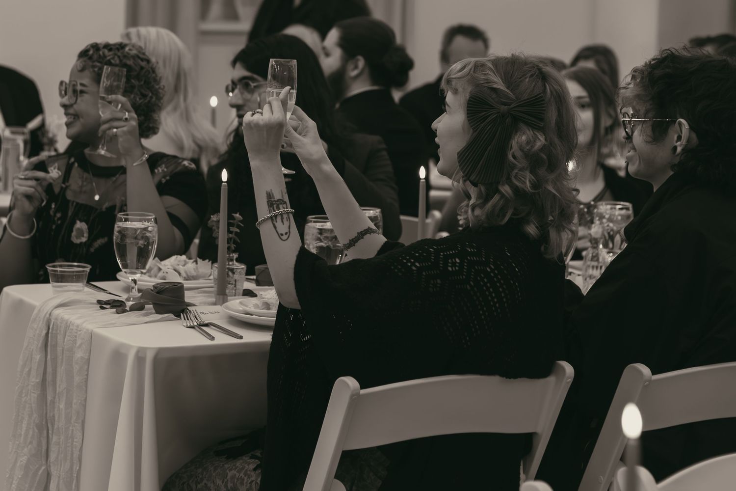 Wedding guests toasting during speeches in Cleveland Ohio by Gypsy Lens Photography. Moody, filmy, vintage, documentary wedding photography.
