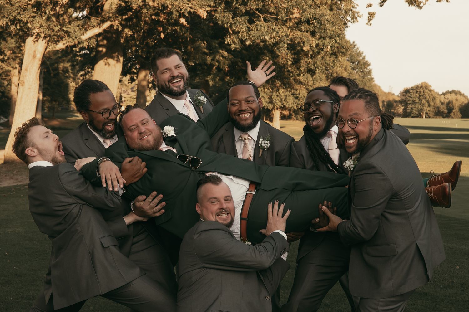 Groomsmen having fun in Akron Ohio by Gypsy Lens Photography. Moody, filmy, vintage, documentary wedding photography.
