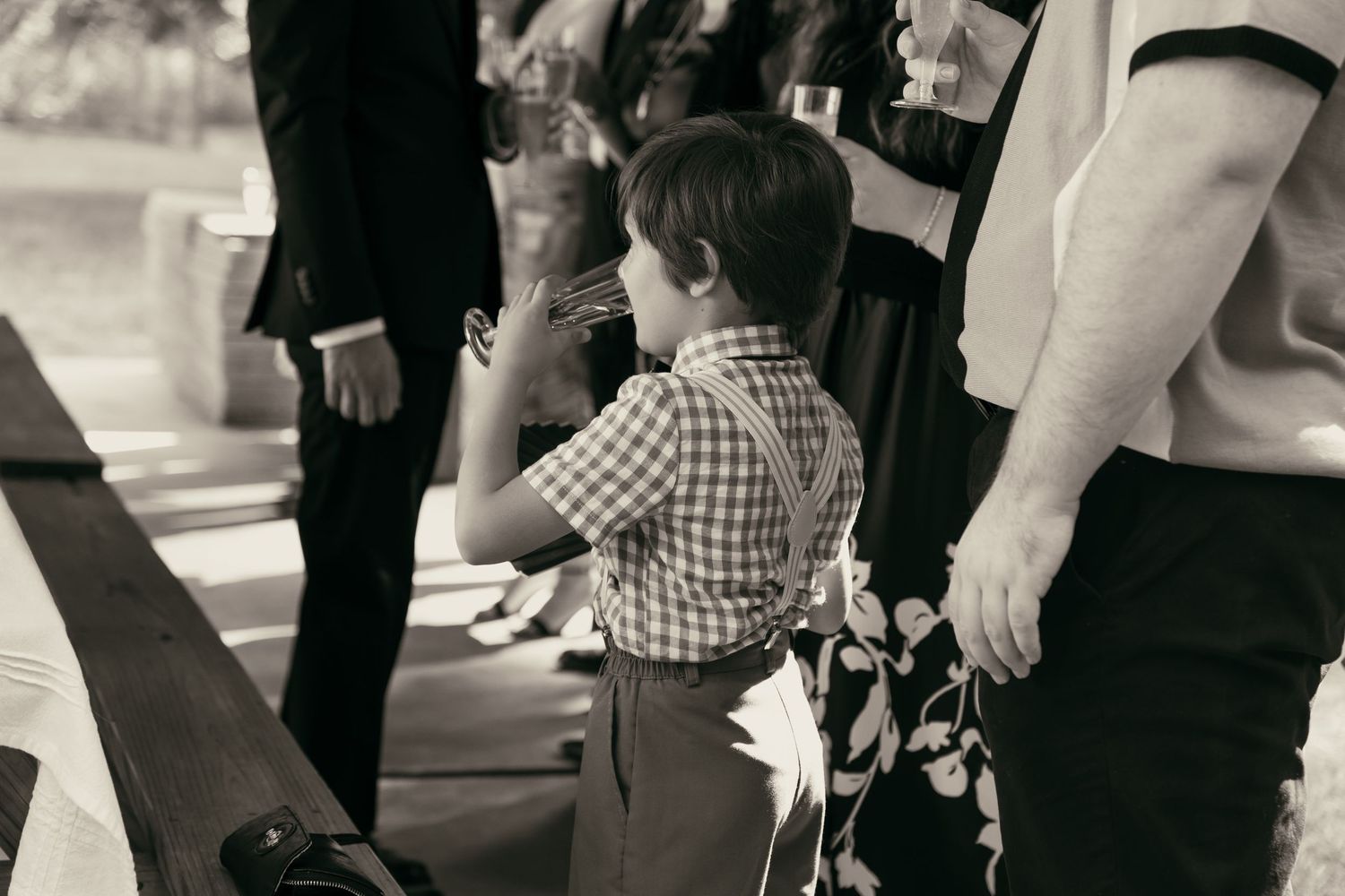 Black and white photo of a young child at cocktail hour in Tallmadge Ohio by Gypsy Lens Photography. Moody, vintage, documentary wedding.