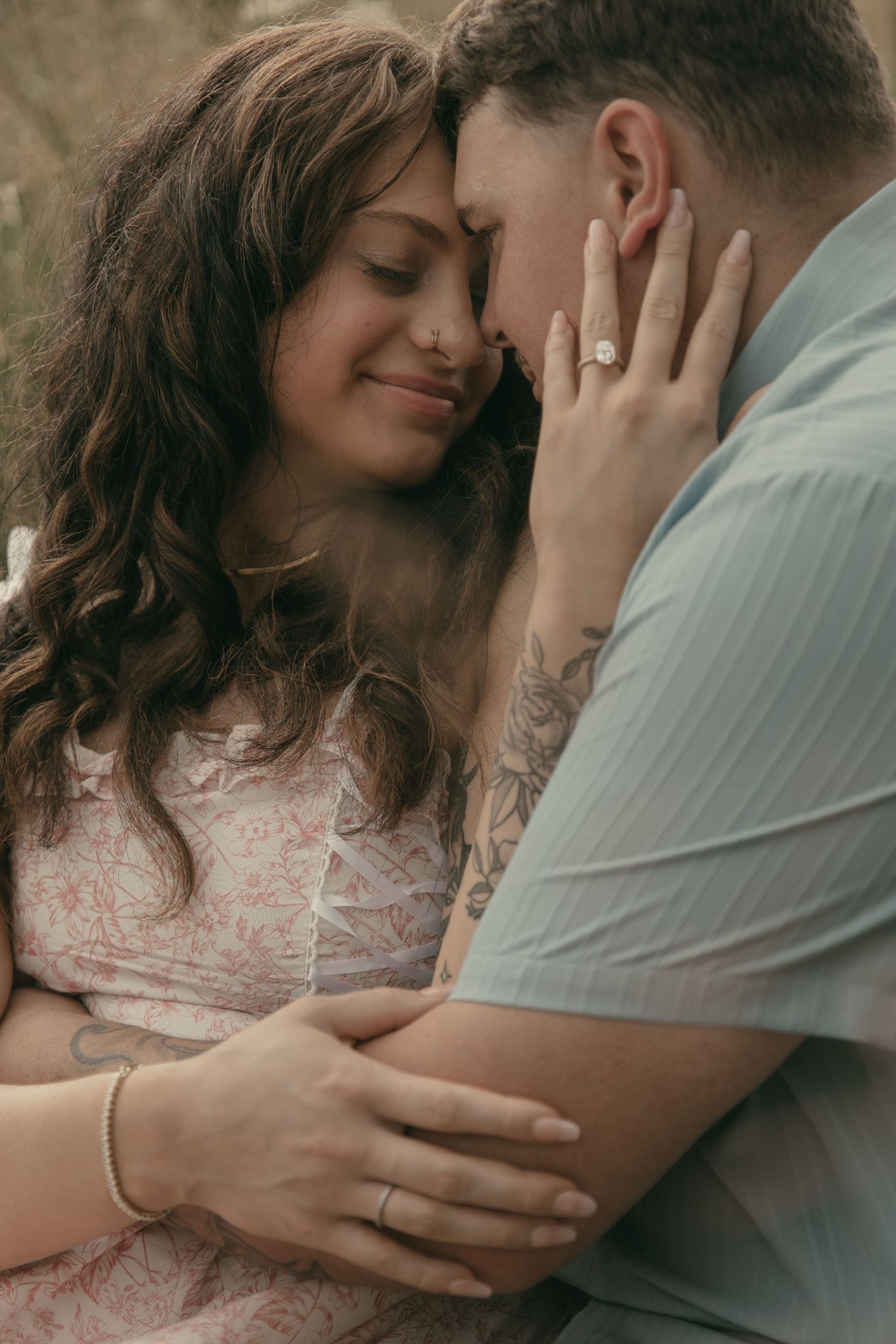 Couple kissing in a wildflower meadow in Lake County Ohio by Gypsy Lens Photography. Moody, filmy, vintage, documentary wedding photography