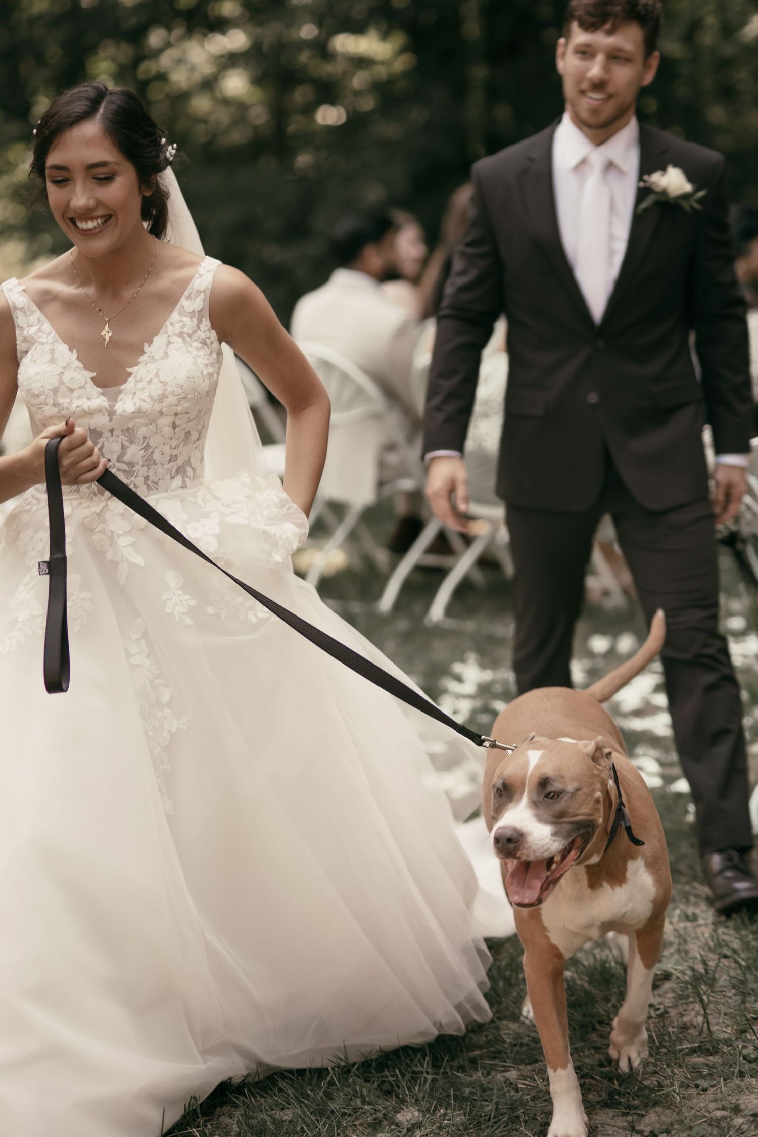 Happy couple walking with their smiling dog down the aisle in Tallmadge Ohio by Gypsy Lens Photography. Moody, vintage, documentary wedding