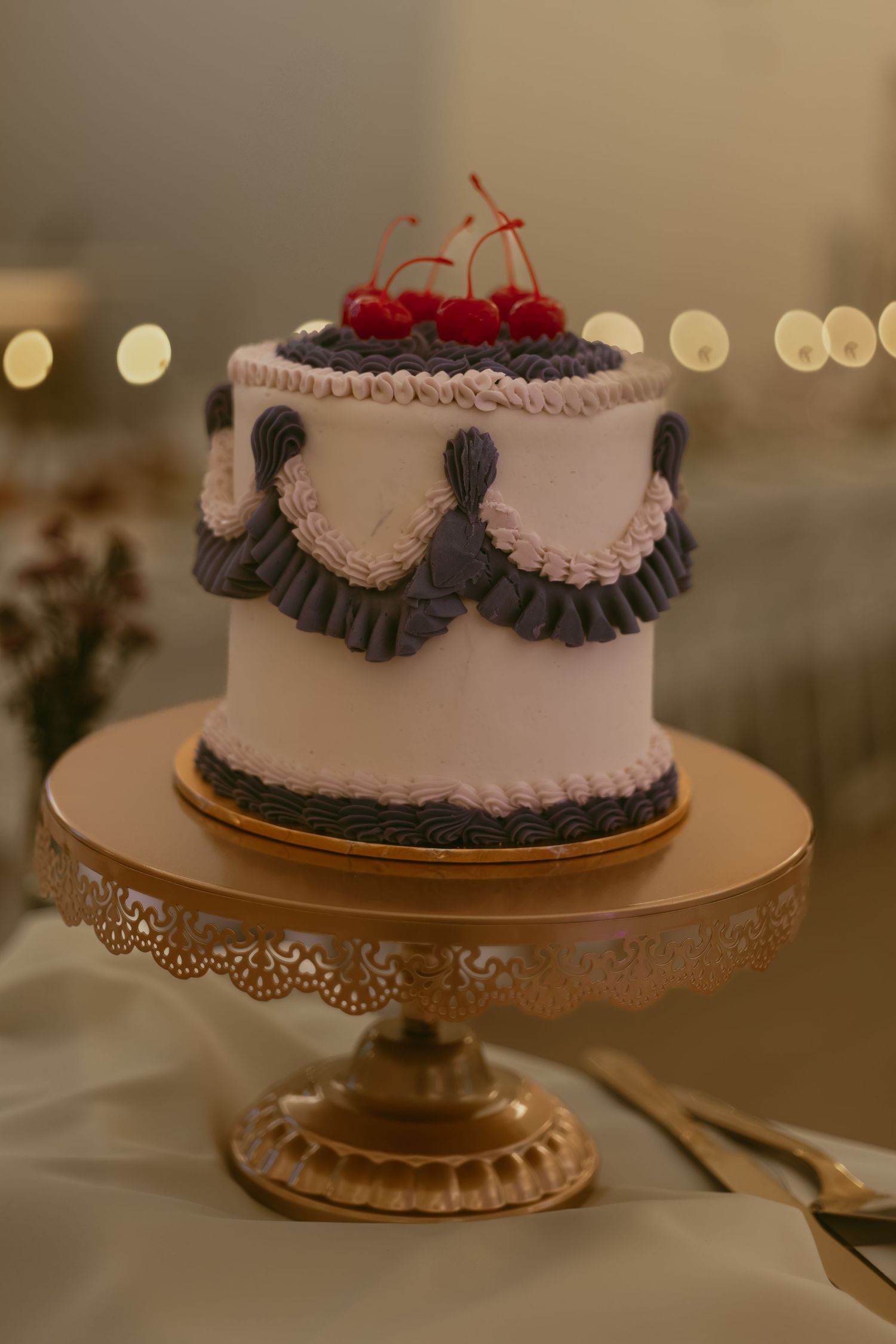 Wedding cake on vintage cake table in Cleveland Ohio by Gypsy Lens Photography. Moody, filmy, vintage, documentary wedding photography.