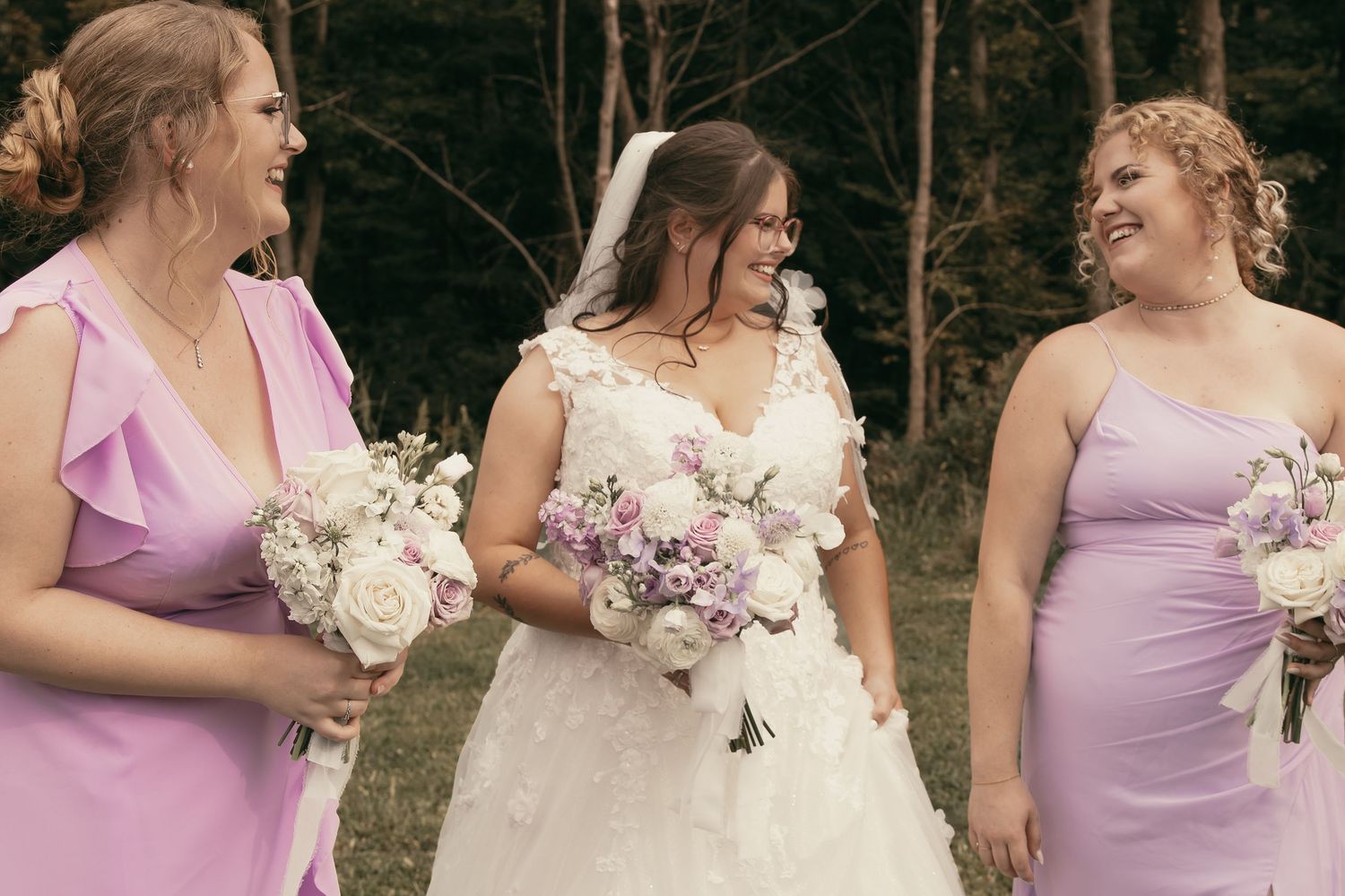 Bride and bridesmaids sharing candid moment in Cleveland Ohio by Gypsy Lens Photography. Moody, vintage, documentary wedding photographer.