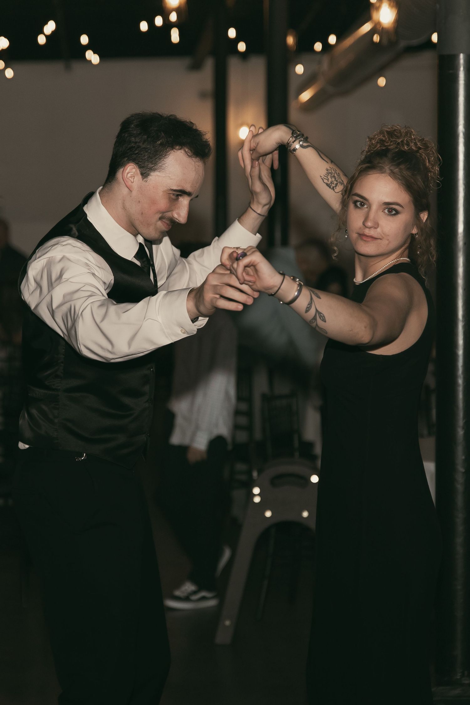 Wedding guests dancing at reception in Cleveland Ohio by Gypsy Lens Photography. Moody, vintage, documentary wedding photographer.