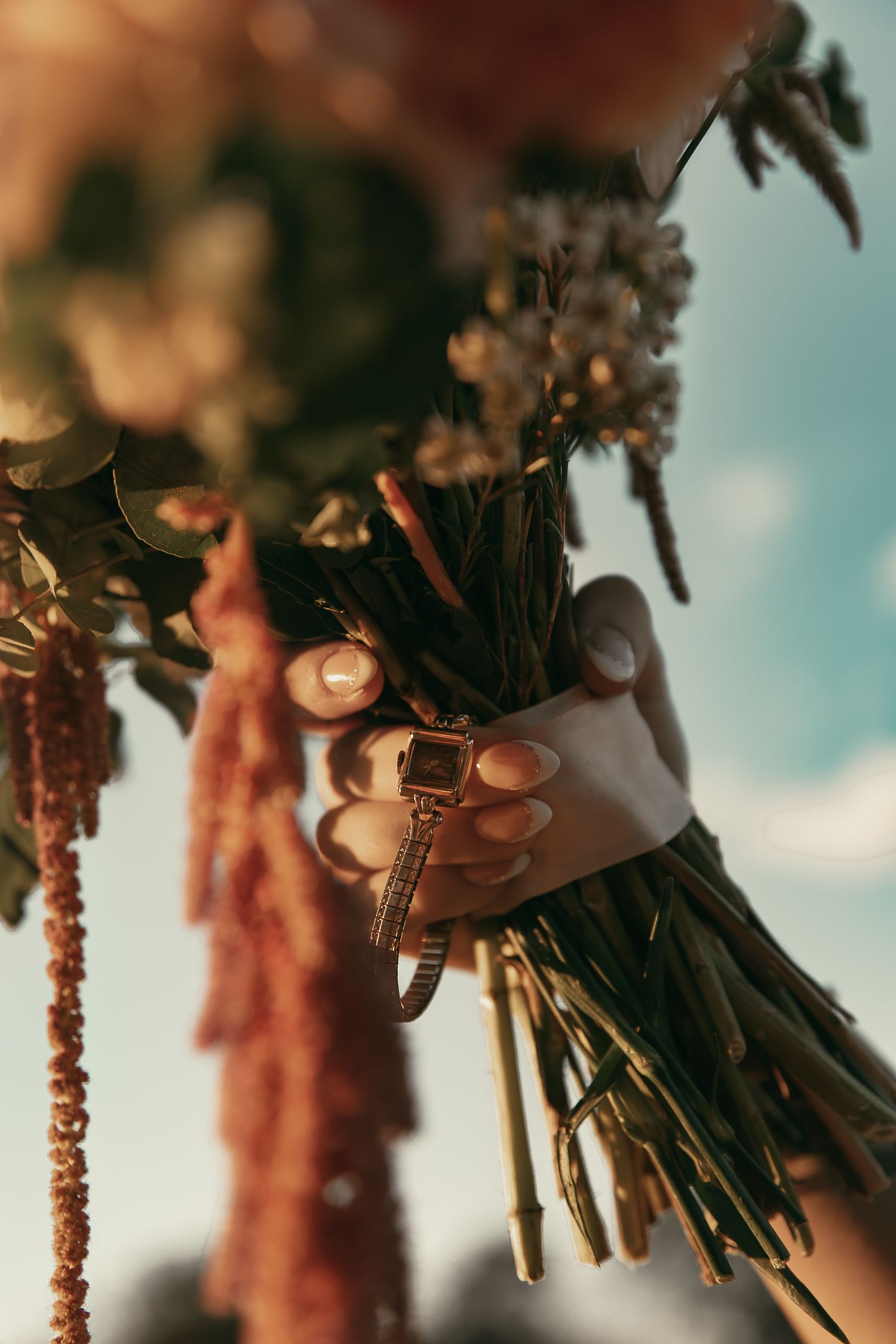 Close up of vintage watch on bouquet in Akron Ohio by Gypsy Lens Photography. Moody, filmy, vintage, documentary wedding photography.