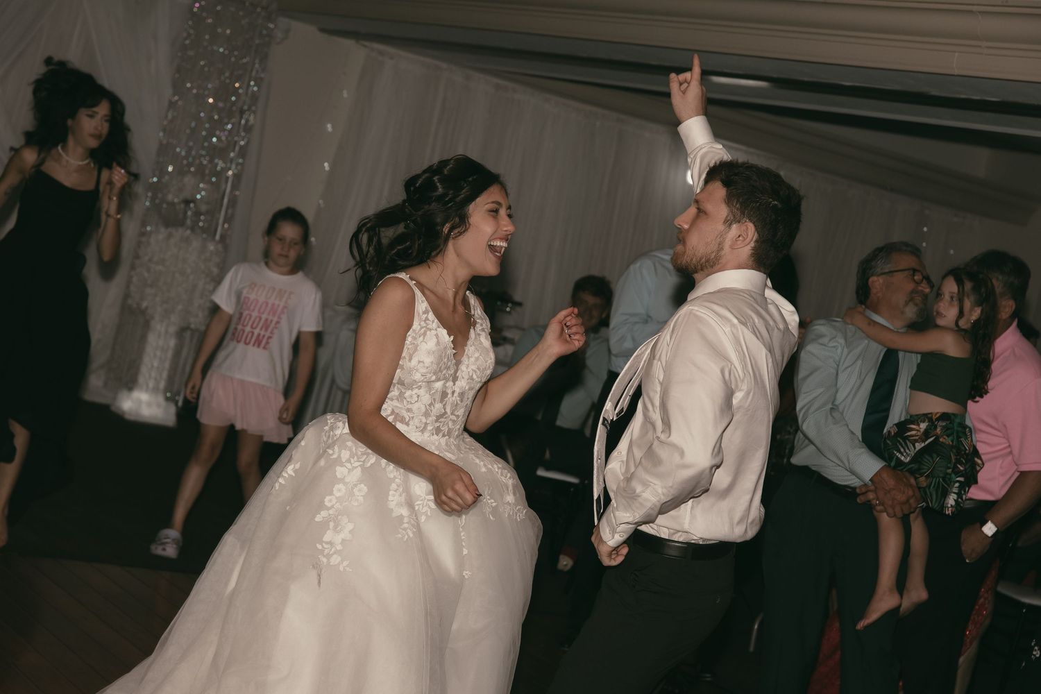 Bride and groom dancing in formal attire at reception party in Tallmadge Ohio by Gypsy Lens Photography. Moody, vintage documentary wedding