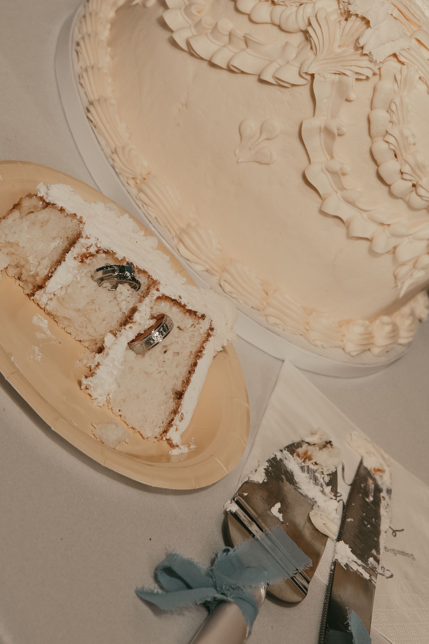 Wedding cake with wedding rings in Hermitage Pennsylvania by Gypsy Lens Photography. Moody, vintage, documentary wedding photo.
