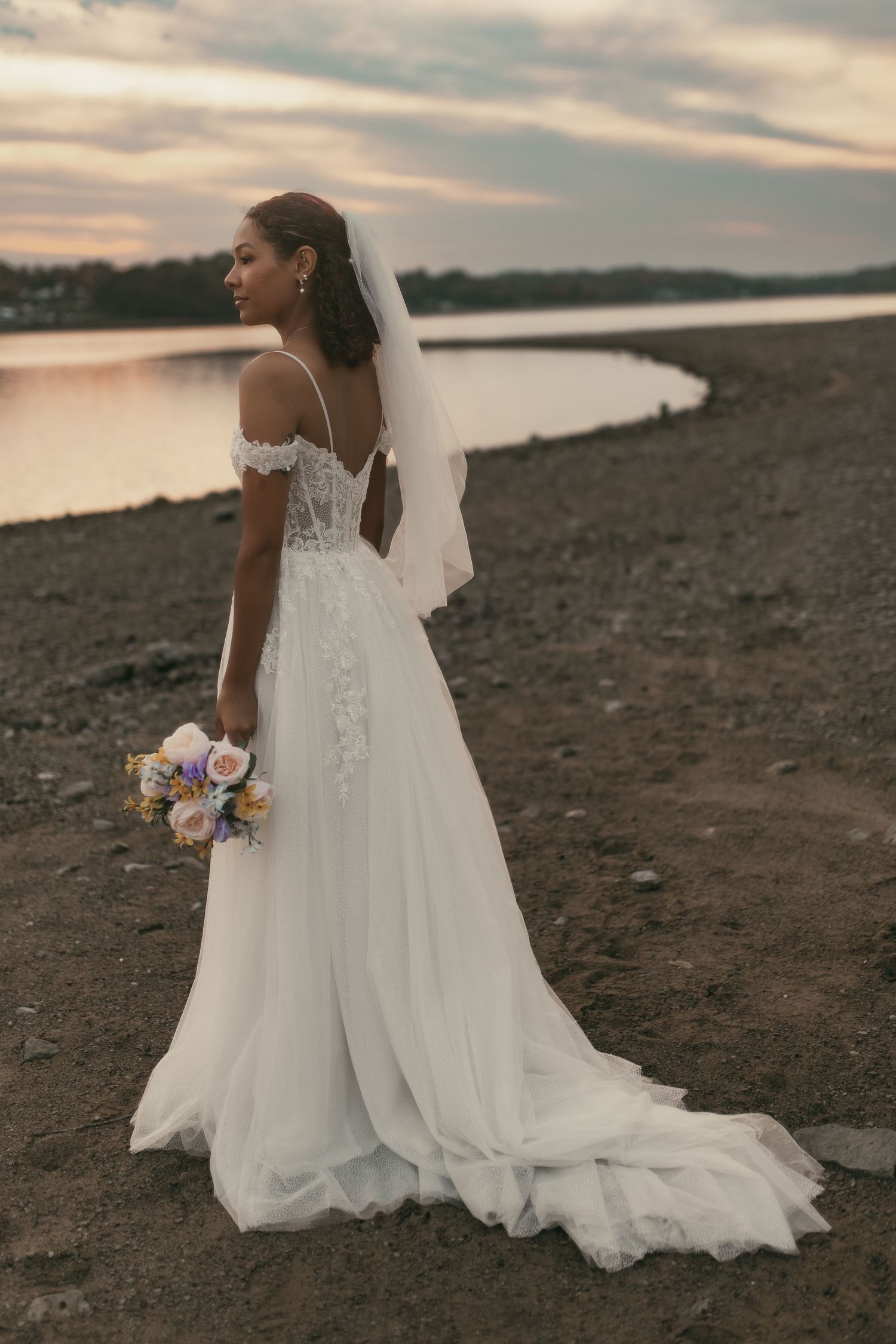 Bride in lace on beach at sunset in Cleveland Ohio by Gypsy Lens Photography. Moody, vintage, documentary wedding photography.