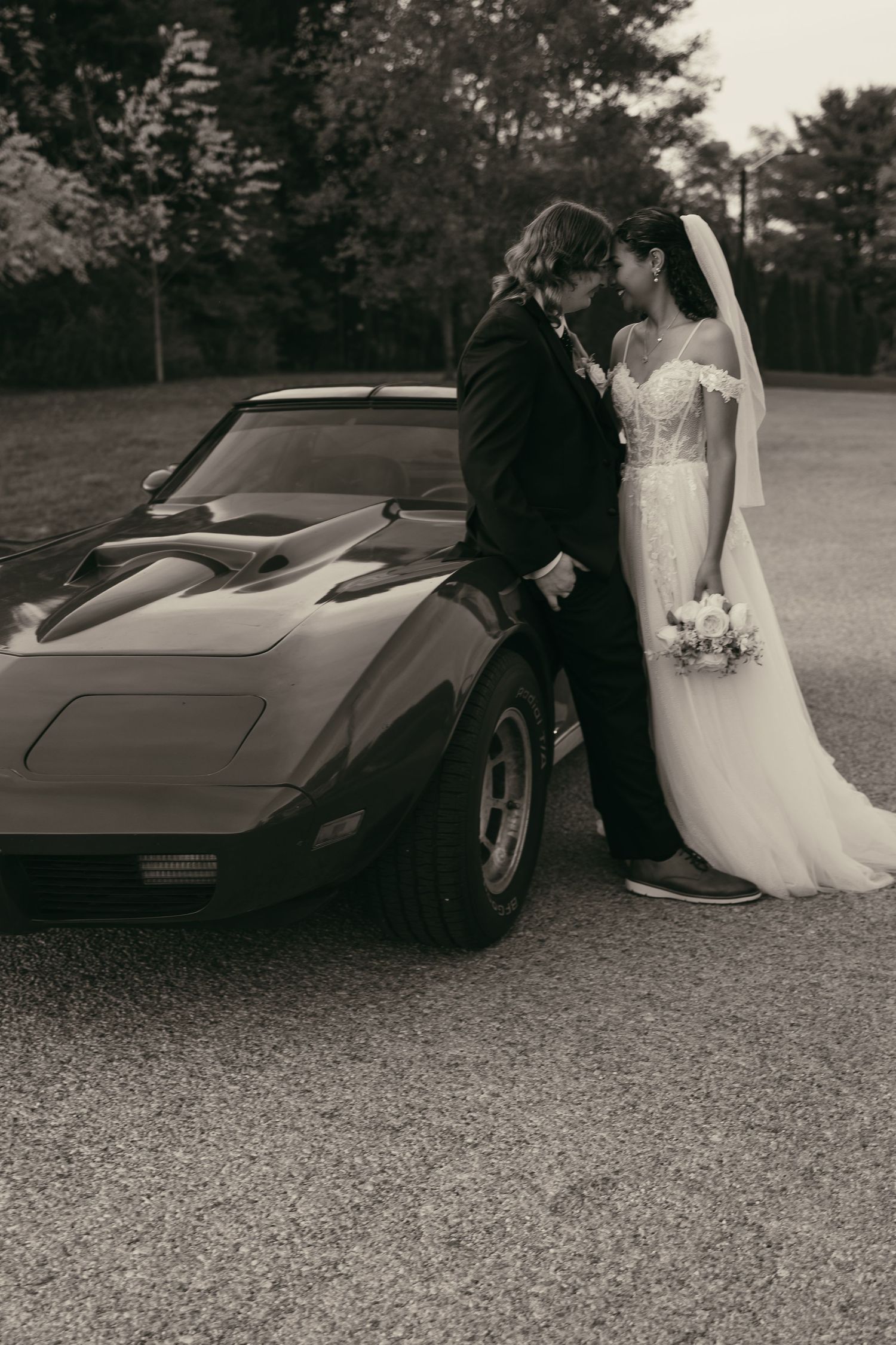 Bride and groom with vintage car kissing in Cleveland Ohio by Gypsy Lens Photography. Moody, vintage, documentary wedding photography.
