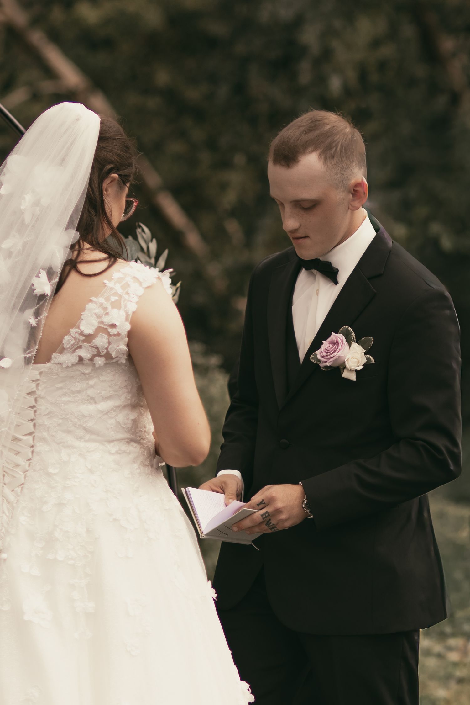 Groom sharing vows at ceremony in Cleveland Ohio by Gypsy Lens Photography. Moody, vintage, documentary wedding photographer.