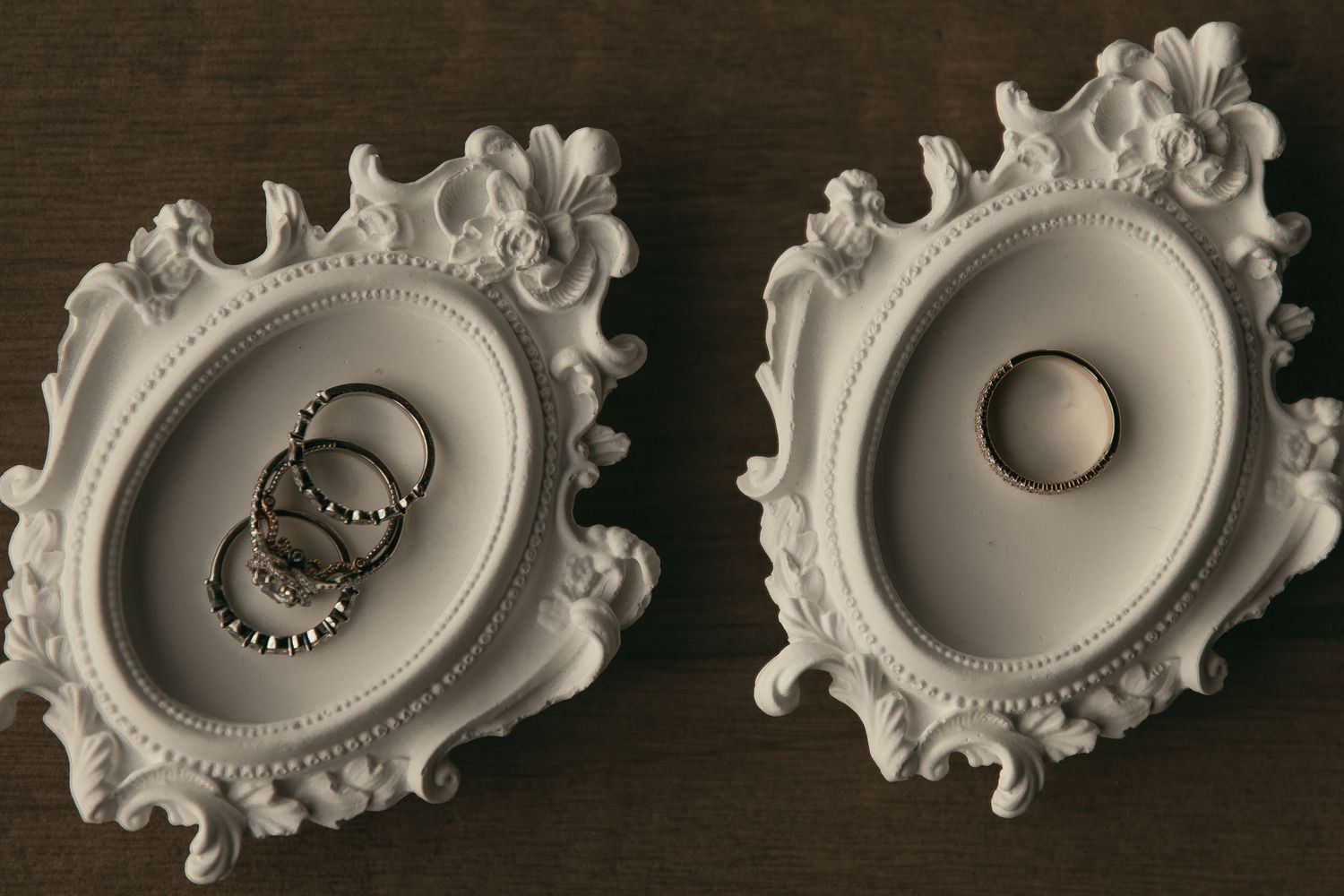 White vintage frames hold wedding rings in Lake County Ohio by Gypsy Lens Photography. Moody, vintage, documentary wedding photography.