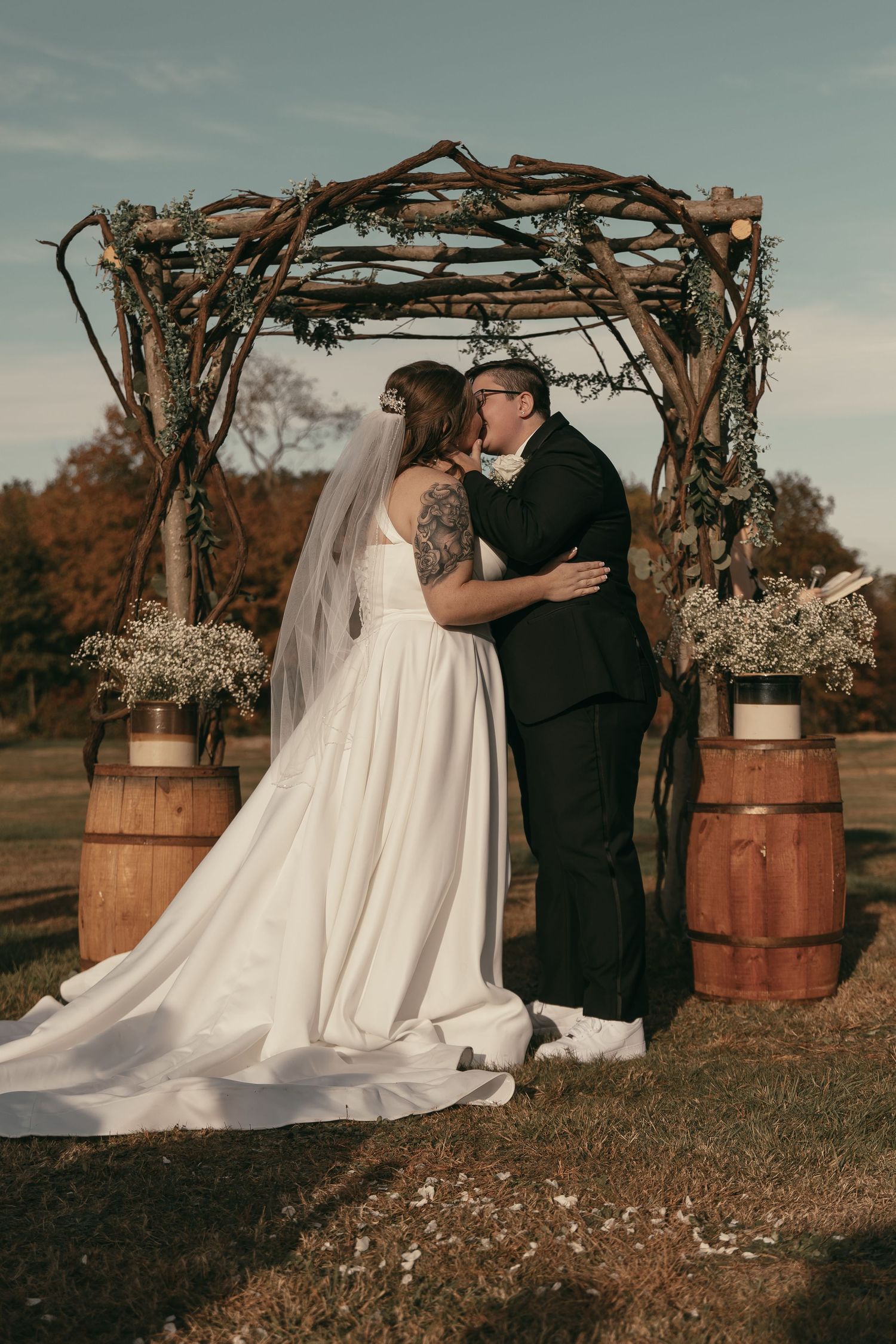 Two brides first kiss during ceremony in Cleveland Ohio by Gypsy Lens Photography. Moody, filmy, vintage, documentary wedding photography.