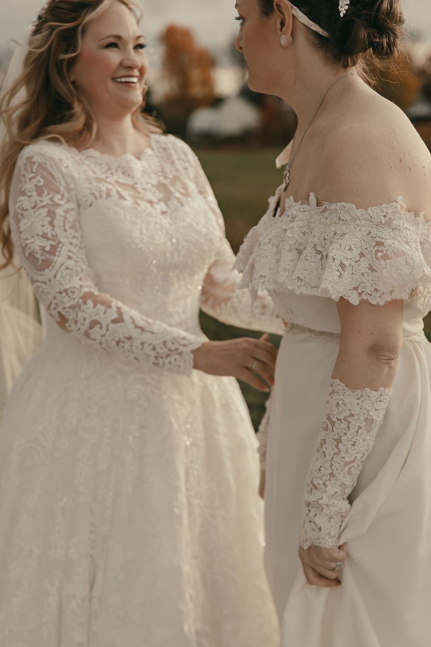 Two brides share a moment during first look in Lake County Ohio by Gypsy Lens Photography. Moody, vintage, documentary wedding photography.