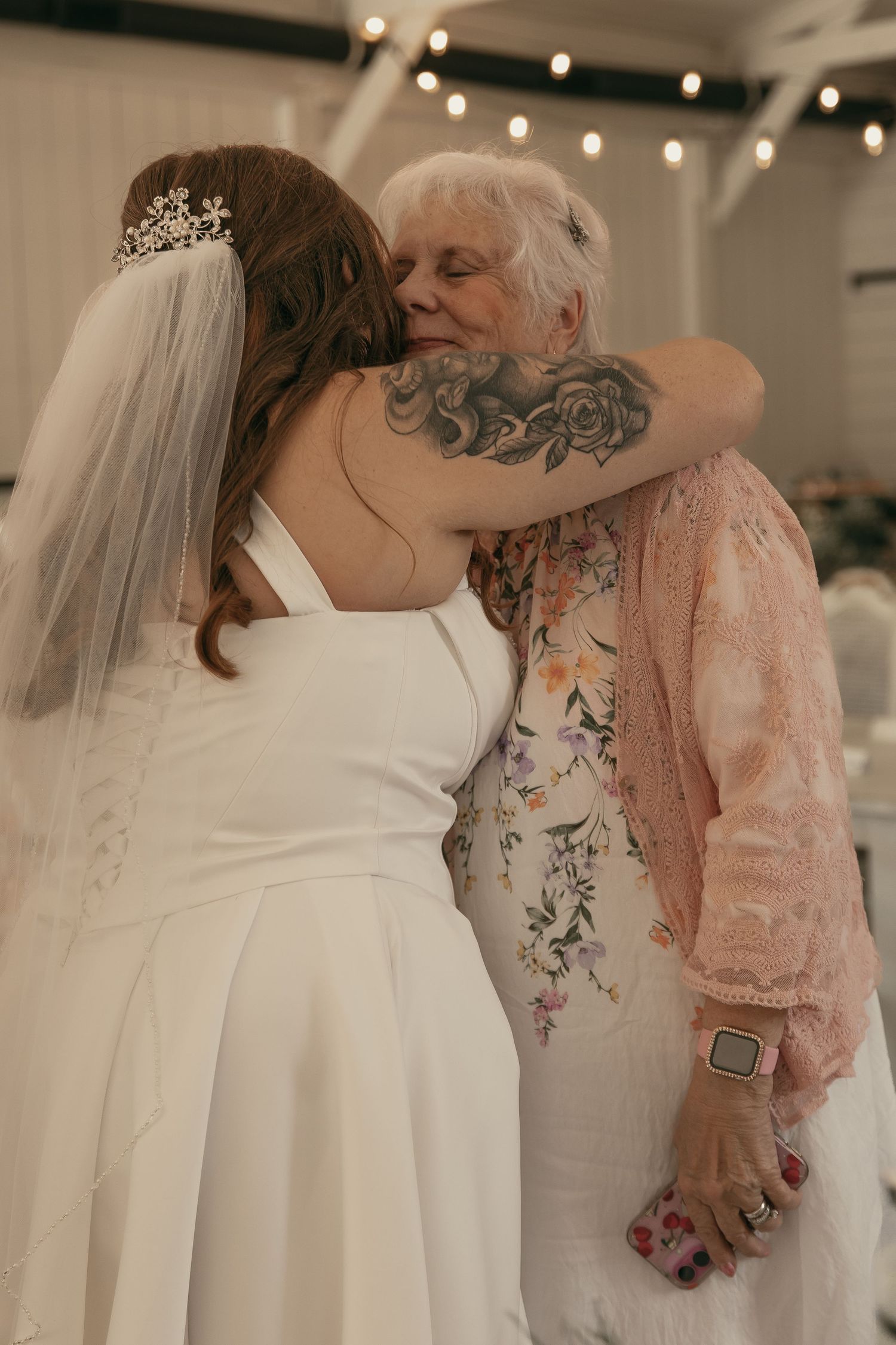 Bride hugging grandma on wedding day in Cleveland Ohio by Gypsy Lens Photography. Moody, vintage, documentary wedding photography.