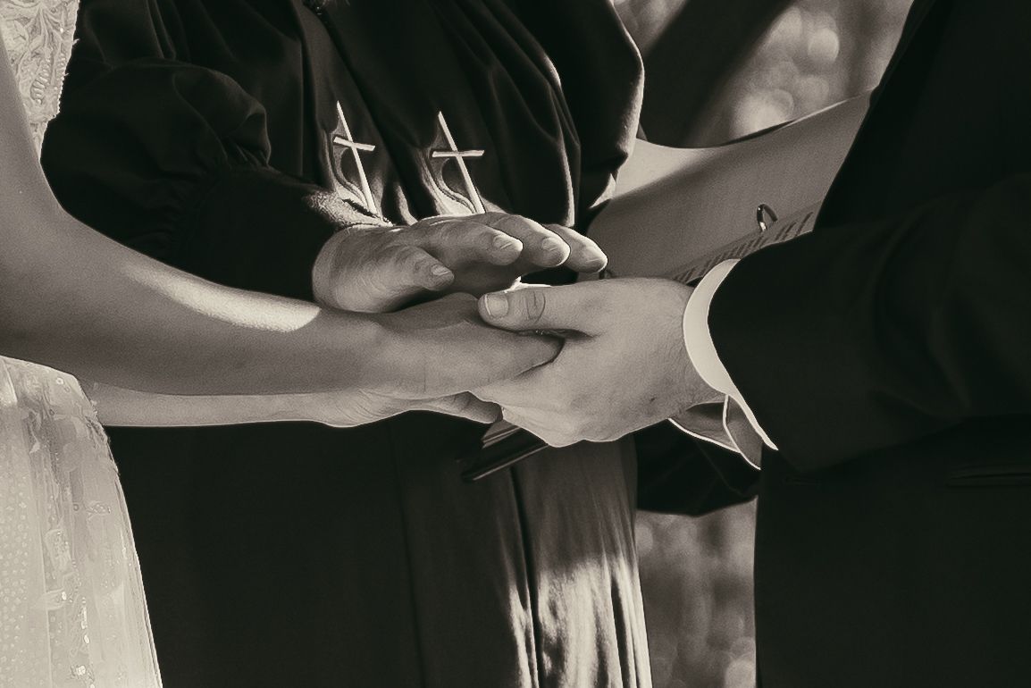 Black and white hands during wedding ceremony in Cleveland Ohio by Gypsy Lens Photography. Moody, vintage, documentary wedding photography.