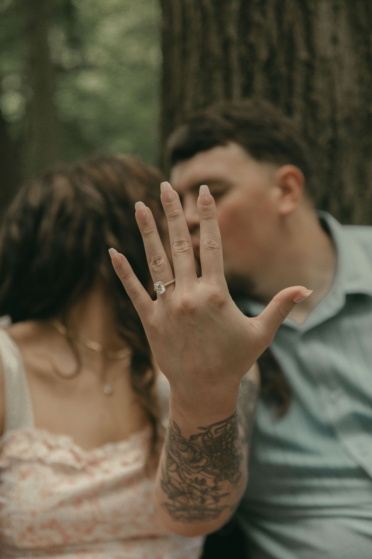 Romantic forest scene couple kissing in Lake County Ohio by Gypsy Lens Photography. Moody, filmy, vintage, documentary wedding photography