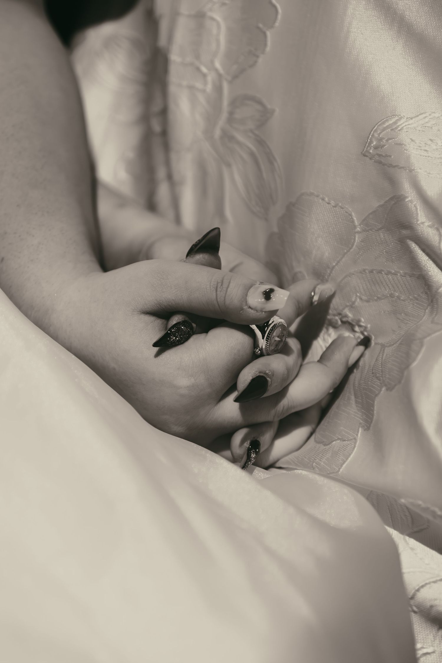 Black and white two hands holding in Cleveland Ohio by Gypsy Lens Photography. Moody, filmy, vintage, documentary wedding photography.