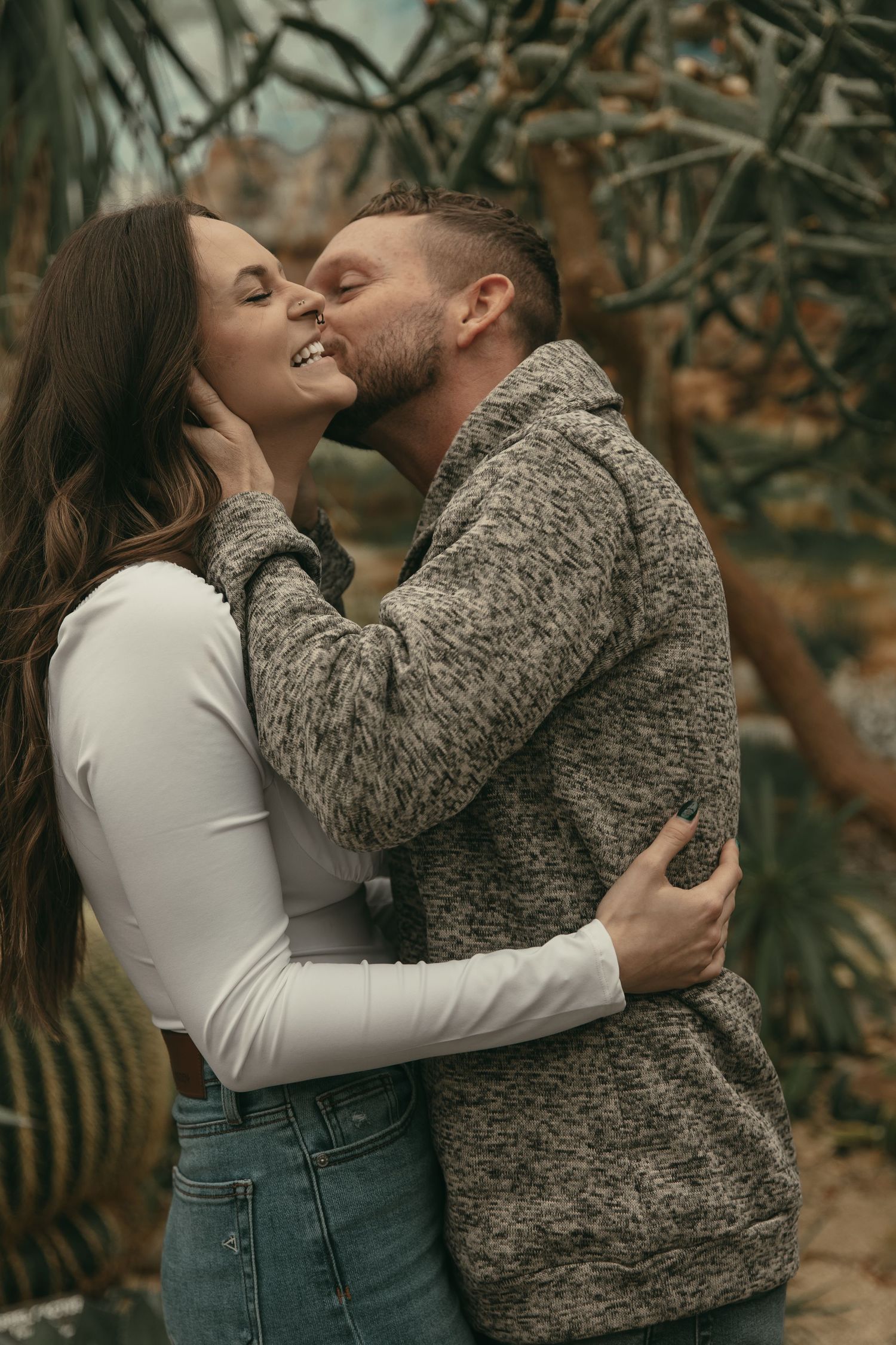 Couple kissing and smiling in Cleveland Ohio by Gypsy Lens Photography. Moody, filmy, vintage, documentary wedding photography