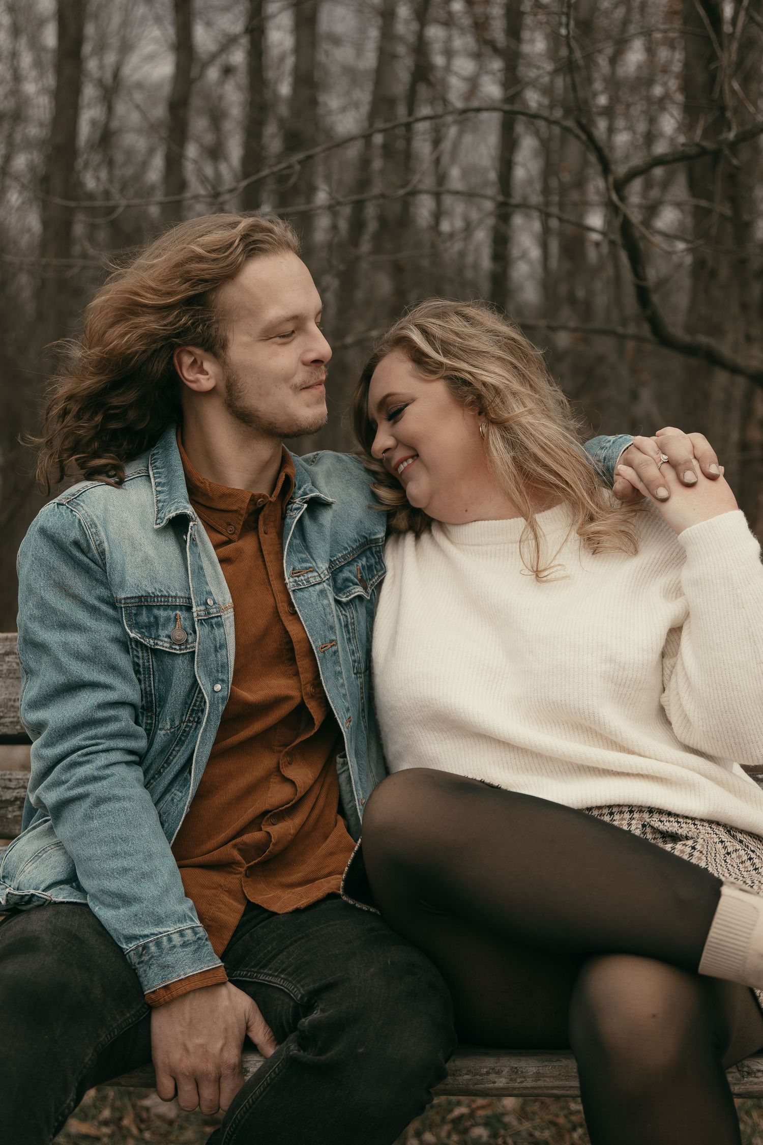Couple sharing moment on bench in Lake County Ohio by Gypsy Lens Photography. Moody, filmy, vintage, documentary wedding photography