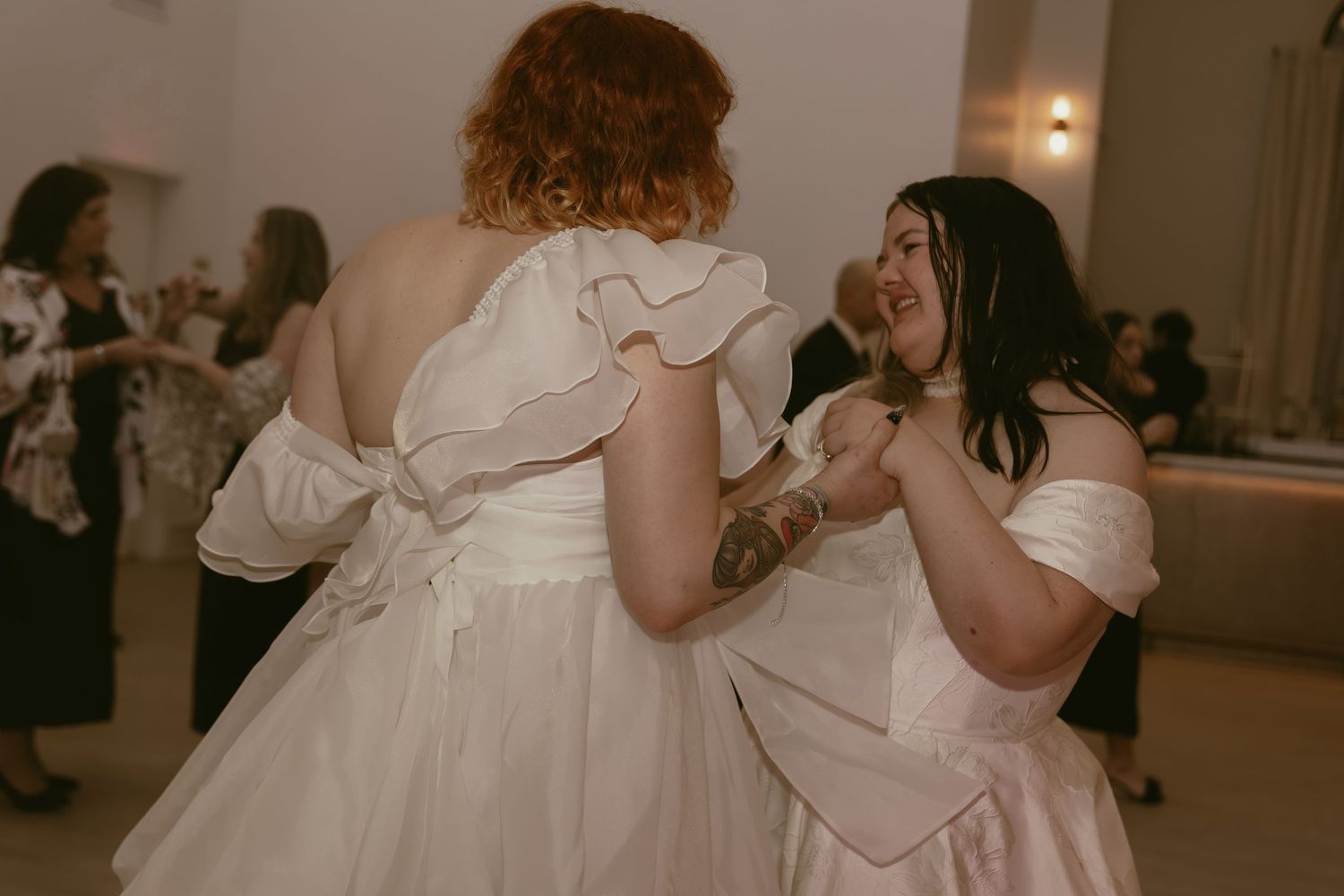 Two brides dancing at wedding reception in Cleveland Ohio by Gypsy Lens Photography. Moody, filmy, vintage, documentary wedding photography.