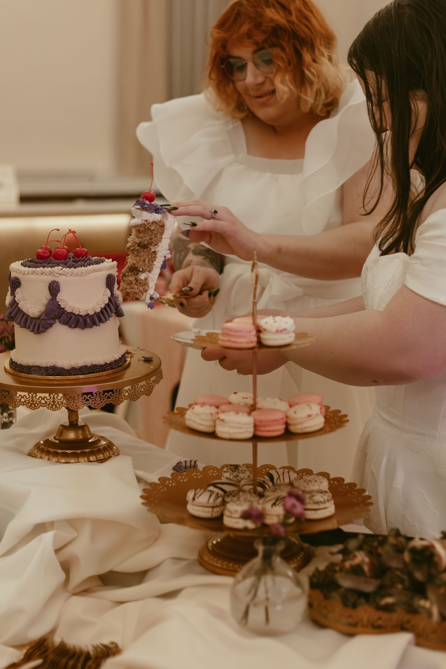 Brides cutting wedding cake in Cleveland Ohio by Gypsy Lens Photography. Moody, filmy, vintage, documentary wedding photography.
