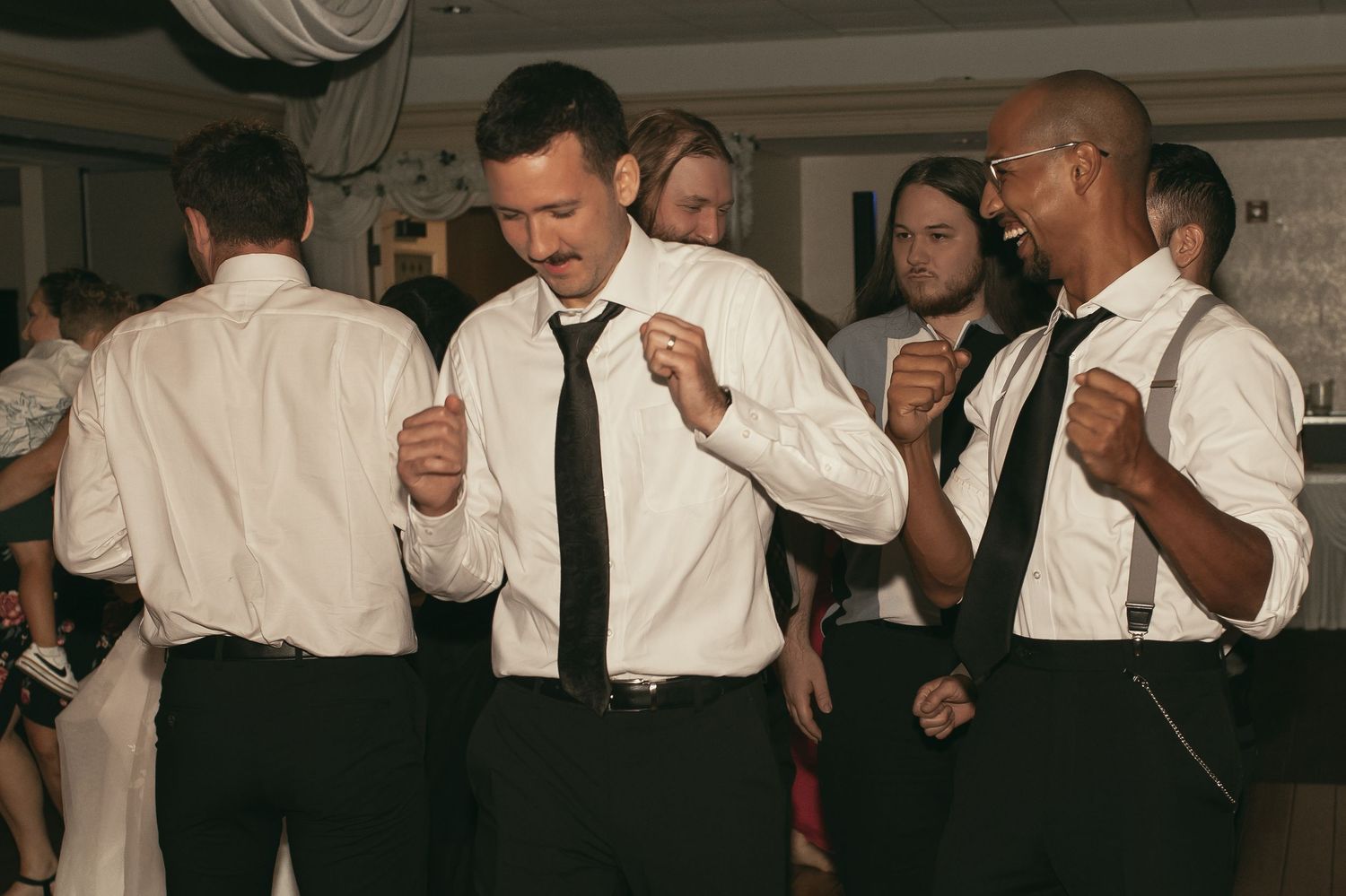 Wedding guests dancing in formal attire at reception party in Tallmadge Ohio by Gypsy Lens Photography. Moody, vintage documentary wedding