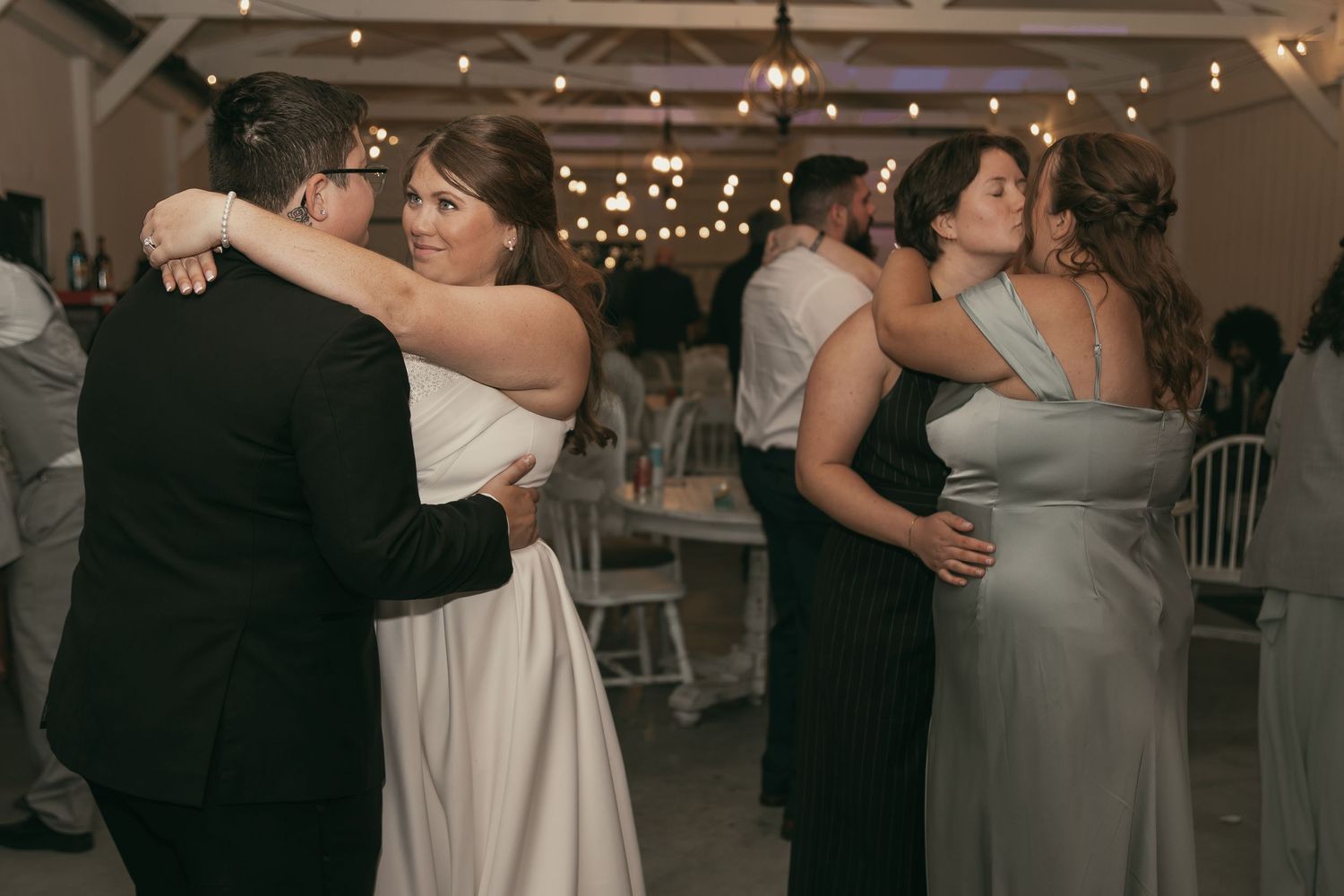 LGBTQ couples slow dancing at reception in Cleveland Ohio by Gypsy Lens Photography. Moody, vintage, documentary wedding photography.