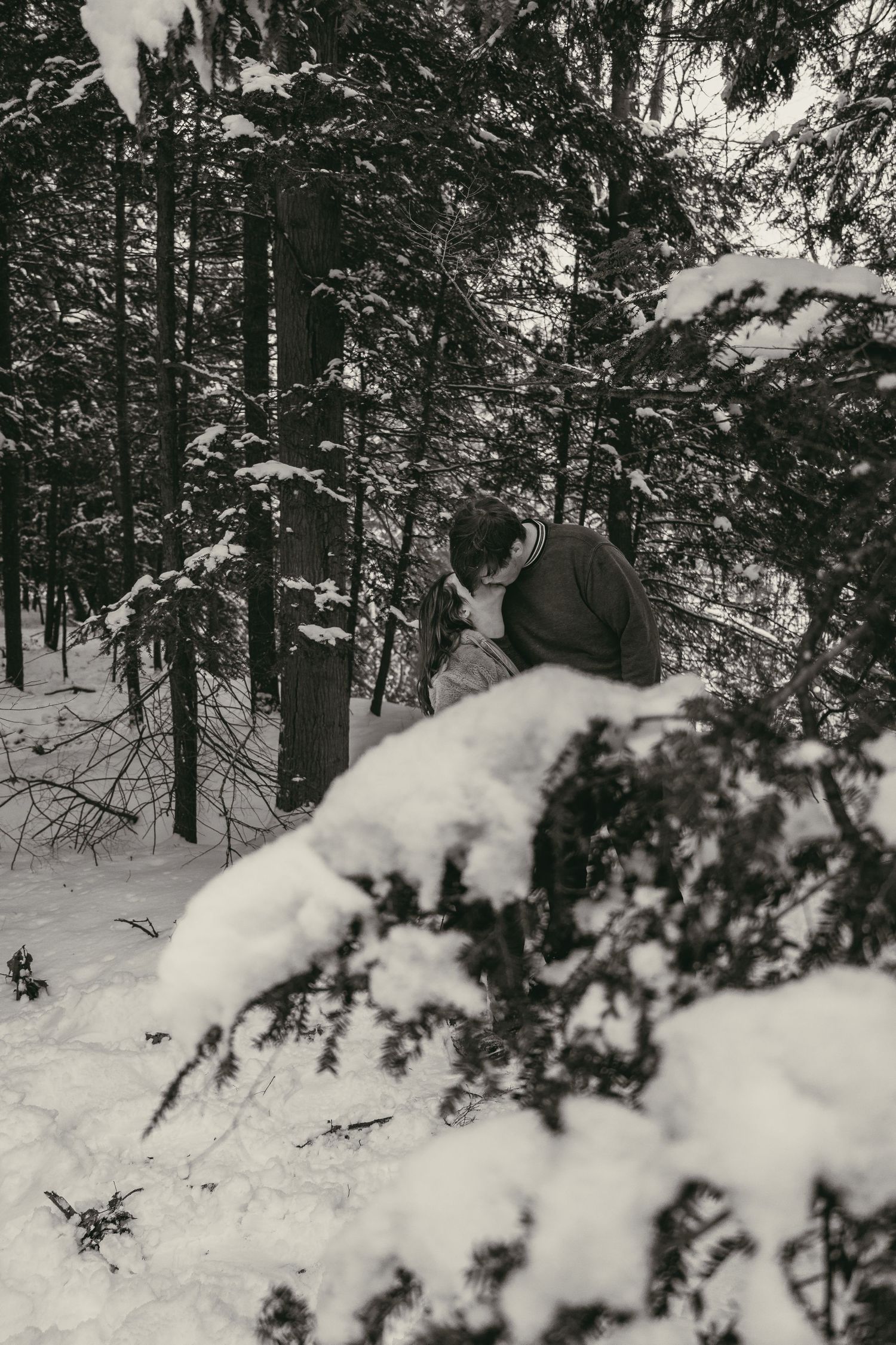 Black and white engaged couple kissing in Lake County Ohio by Gypsy Lens Photography. Moody, filmy, vintage, documentary wedding photo