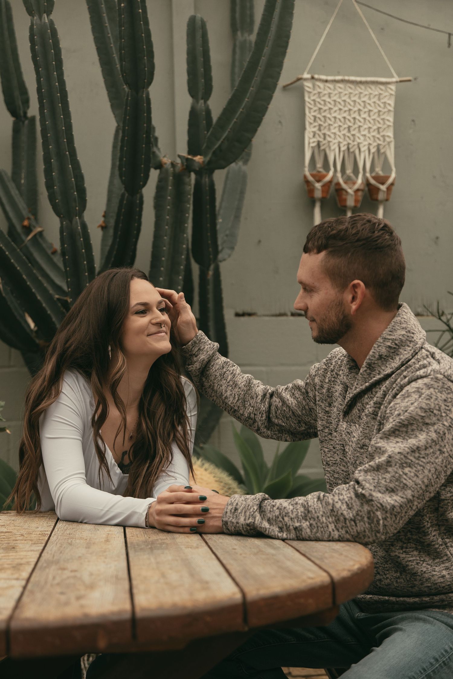 Engaged couple smiling at greenhouse in Cleveland Ohio by Gypsy Lens Photography. Moody, filmy, vintage, documentary wedding photography