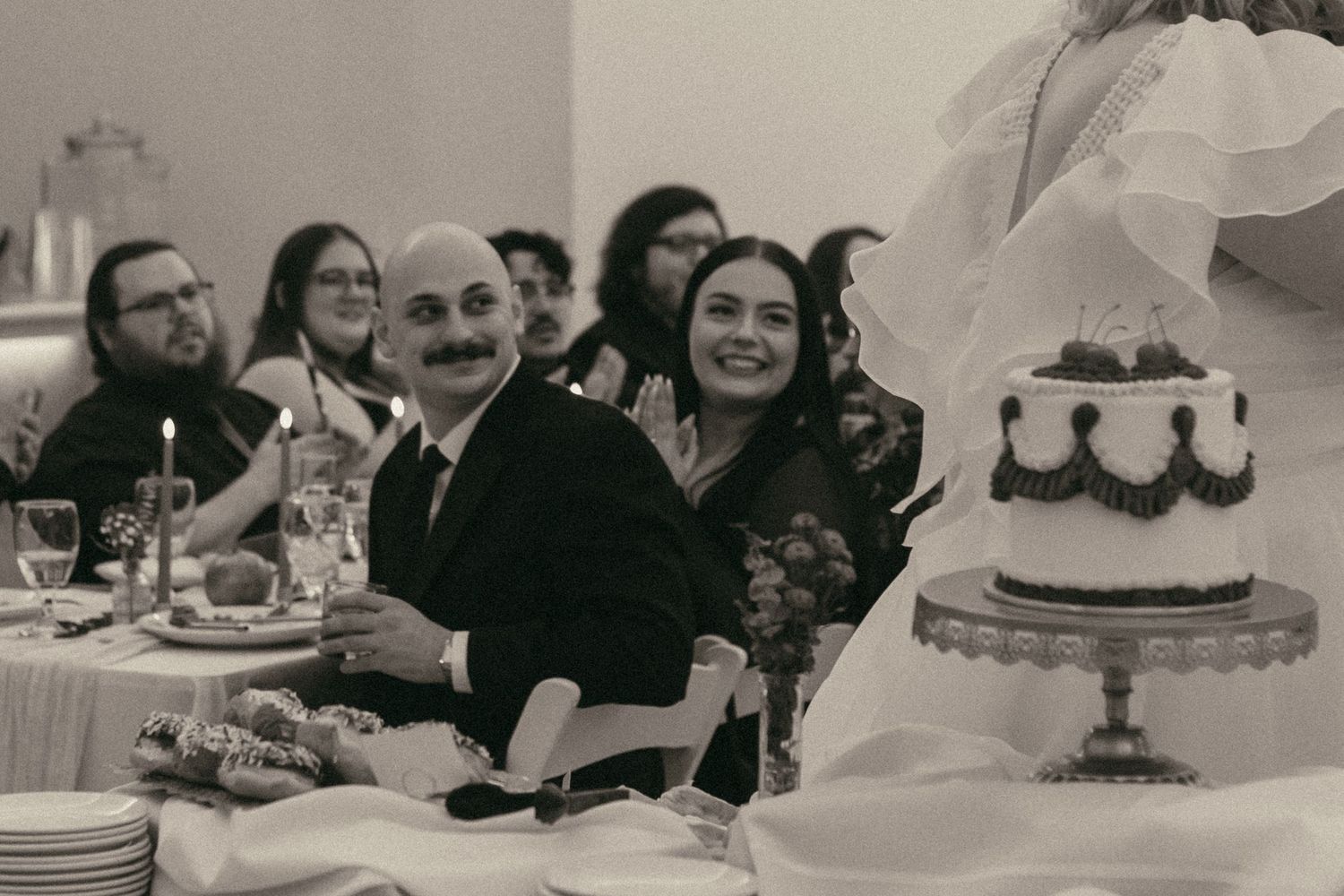 Wedding guests smiling at brides in Cleveland Ohio by Gypsy Lens Photography. Moody, filmy, vintage, documentary wedding photography.